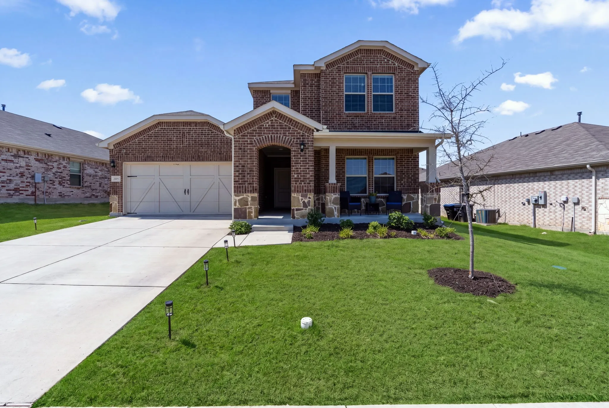 Brick exterior with stone accents and a covered front porch