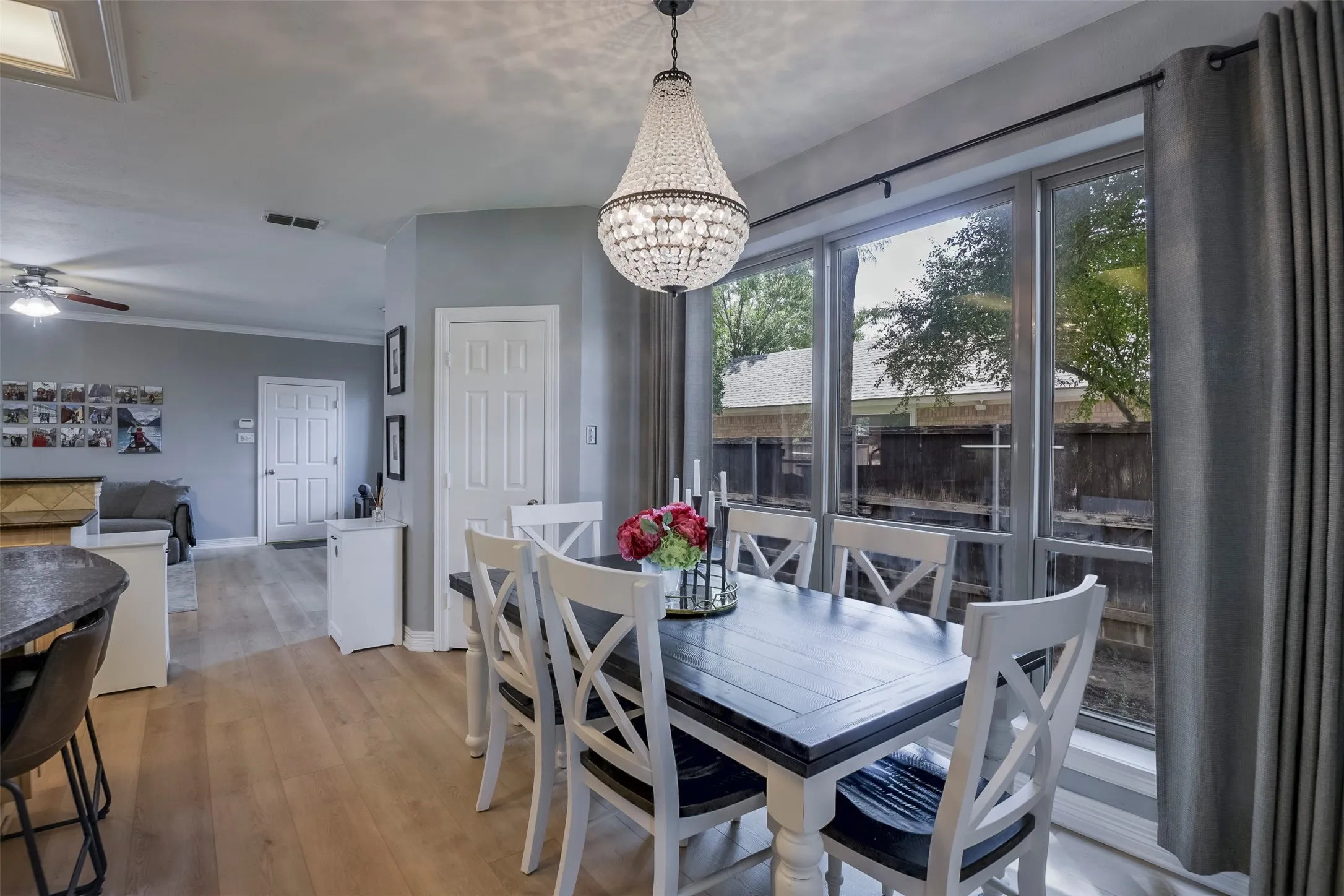 Dining area featuring a crystal chandelier and large window with dark trim