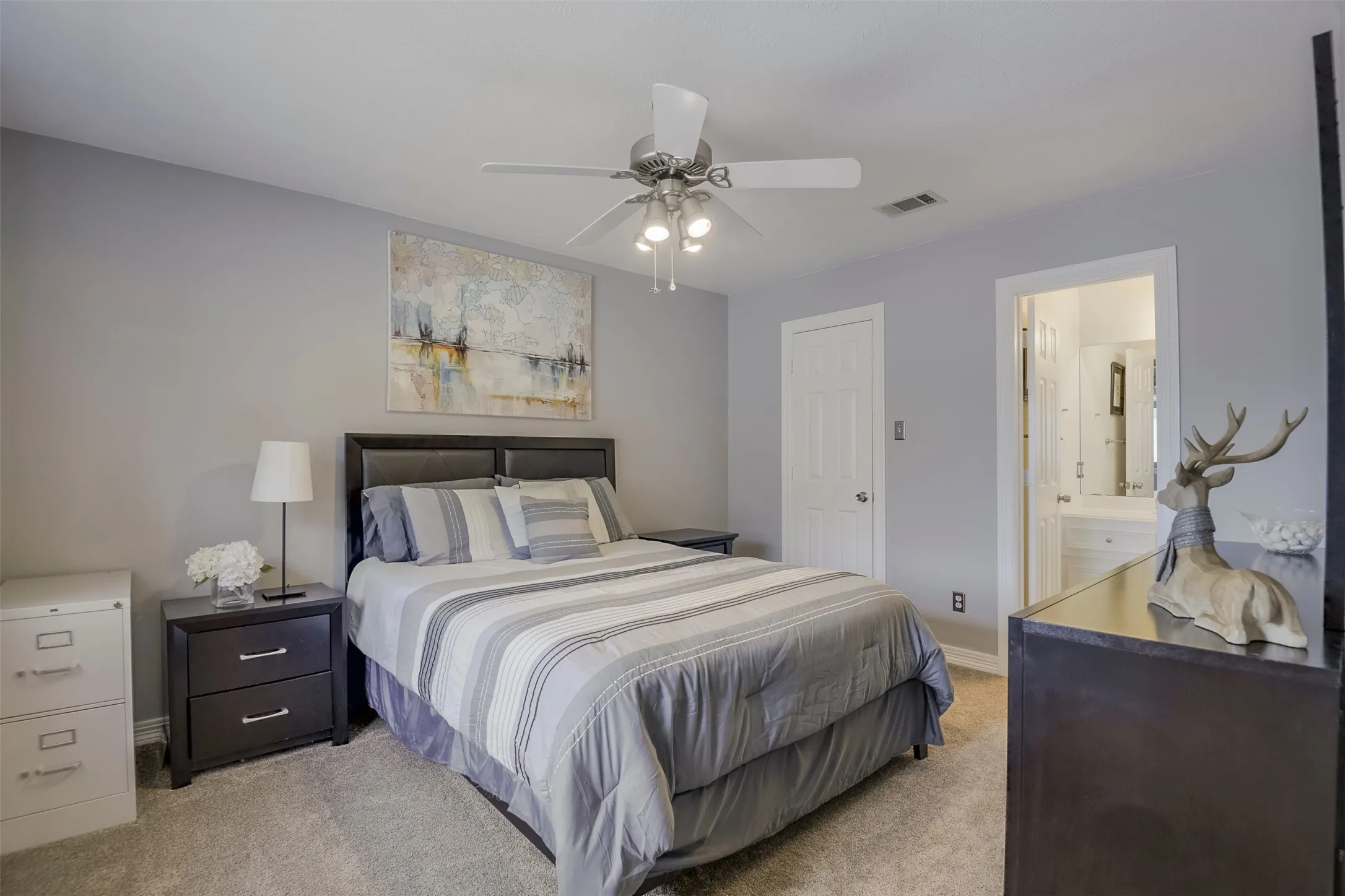 Secondary bedroom suite with walk-in closet, double vanity sinks and bathtub