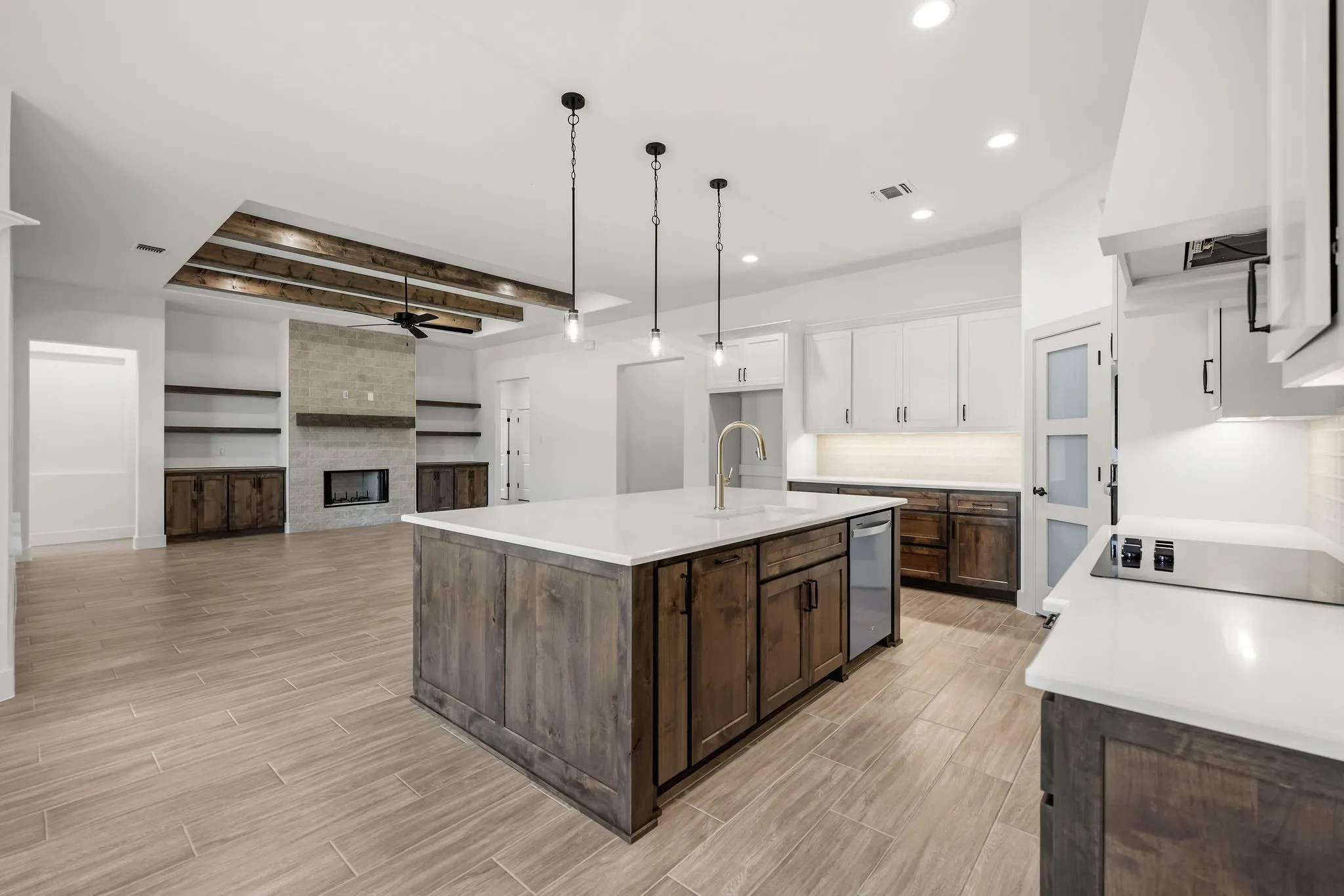 Kitchen with a center island, white countertops, and wood-finish flooring
