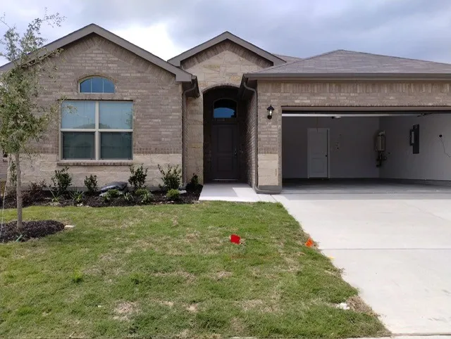 Brick and stone veneer exterior with an arched entry door
