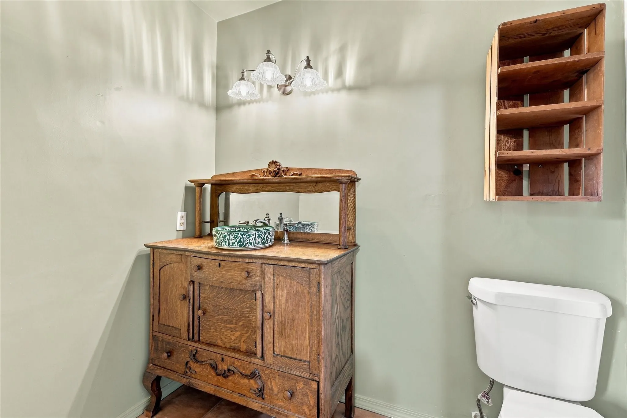Primary ensuite bath features vintage cabinet and recently installed tile.