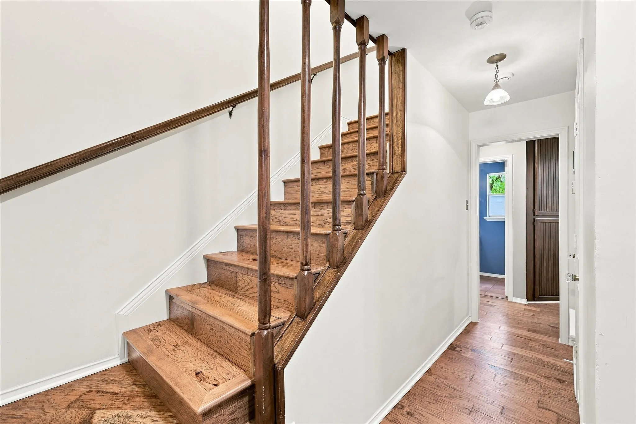 Front entry features a coat closet and wood stairs