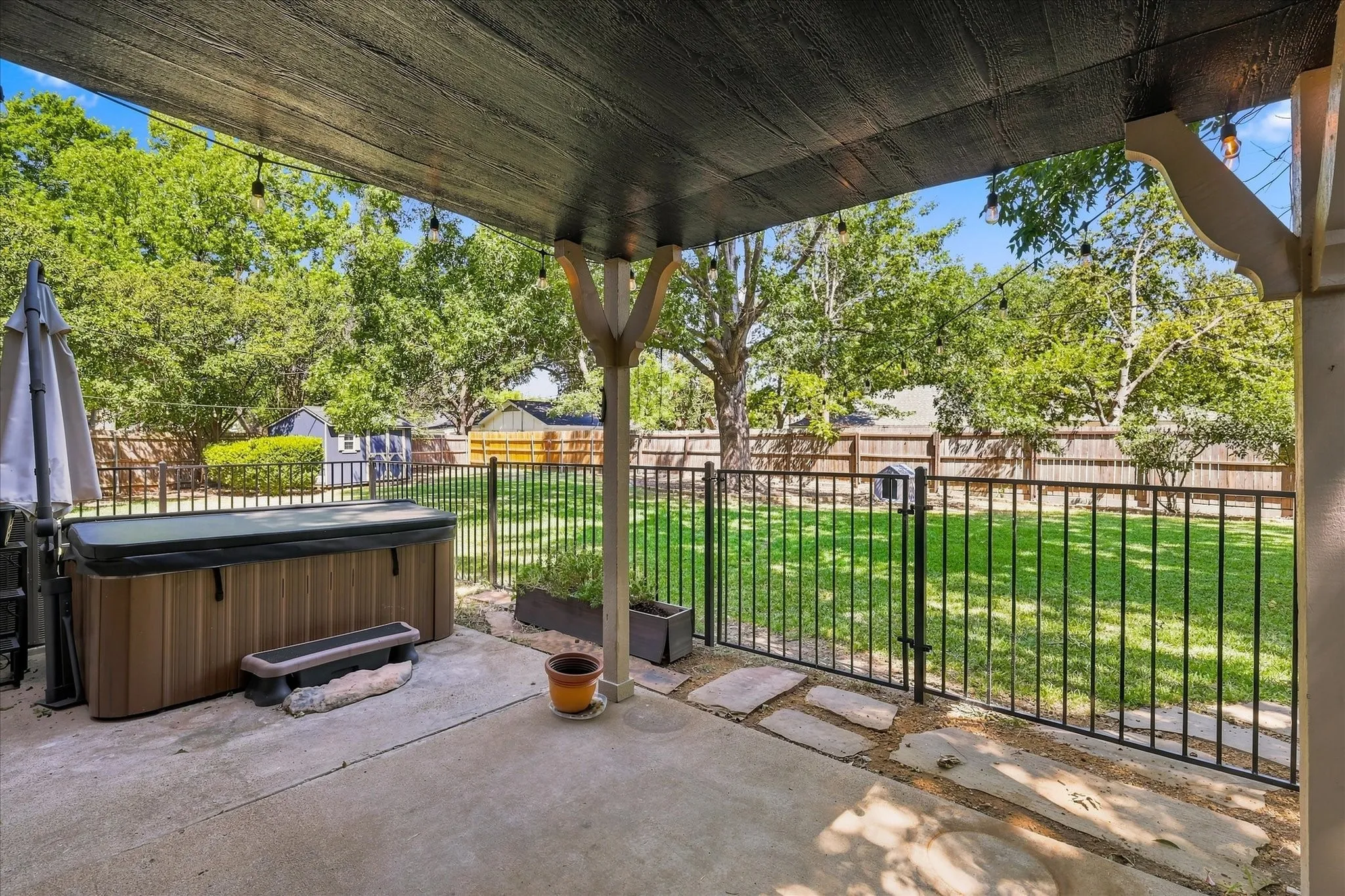 Expansive covered patio with hot tub.