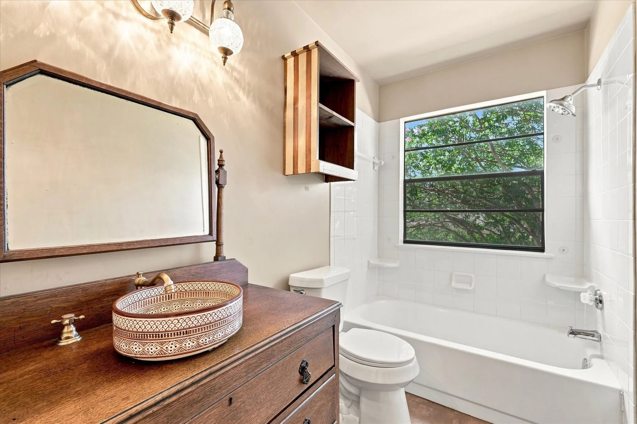 Second-story hall bath features vintage cabinetry and recently installed tile floor.