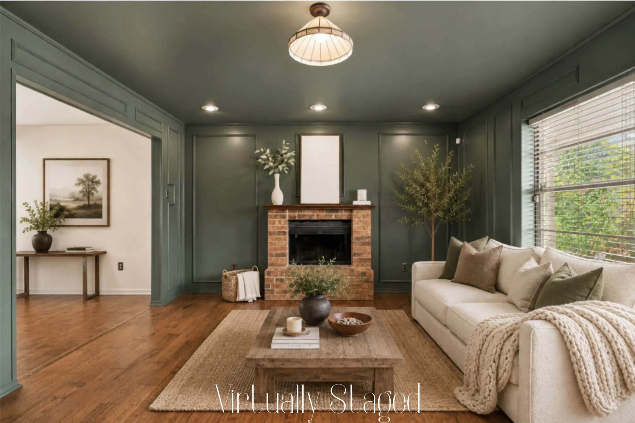 The living room features beautiful wood floors and on-trend color-drenched paint. A brick wood-burning fireplace features a raised hearth and wood mantel.  Lots of natural light fills this cozy room from the front windows.