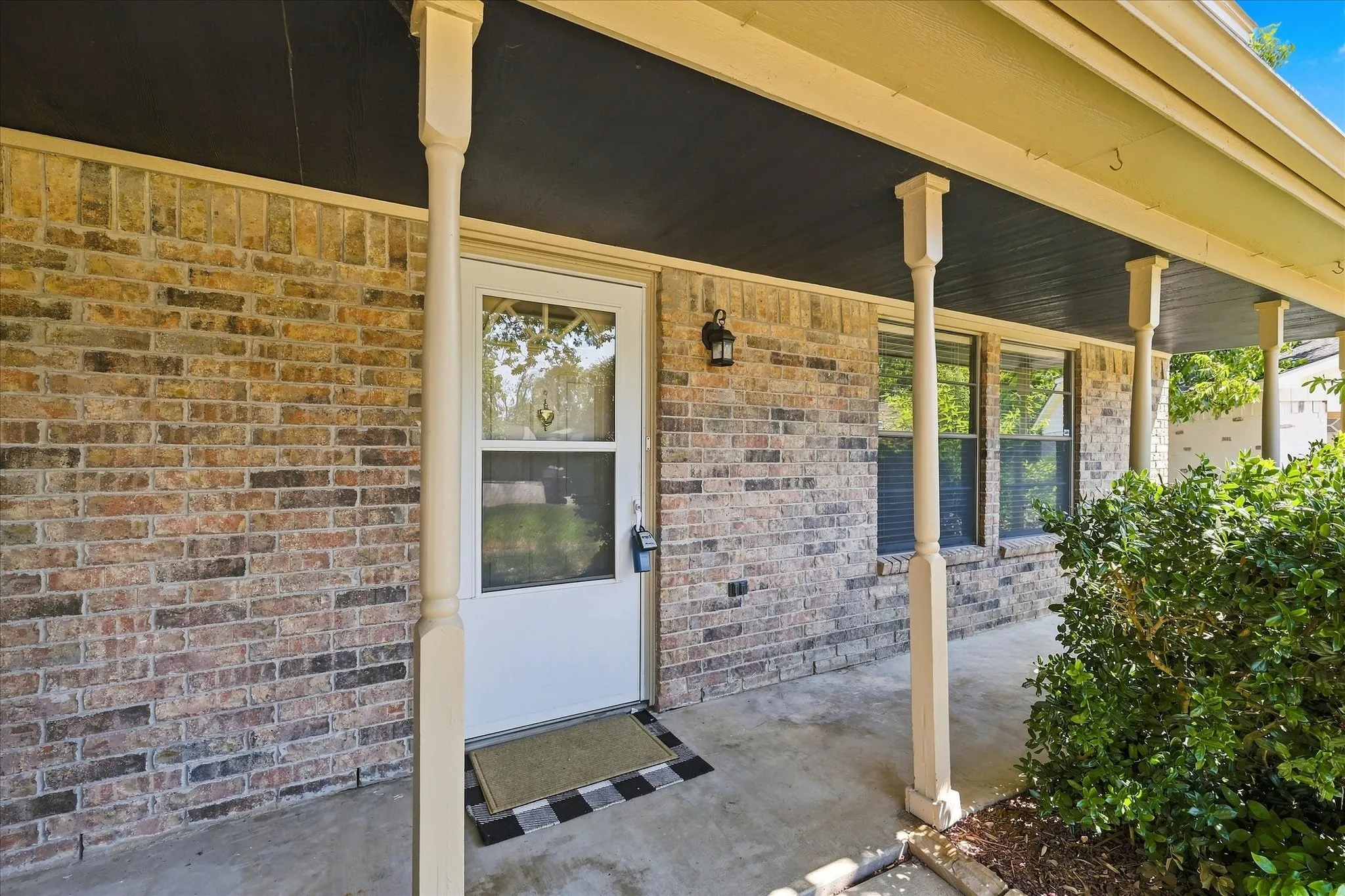 The expansive covered front porch offers a welcoming outdoor space with plenty of room for a table and chairs, potted plants, and seasonal decor.
