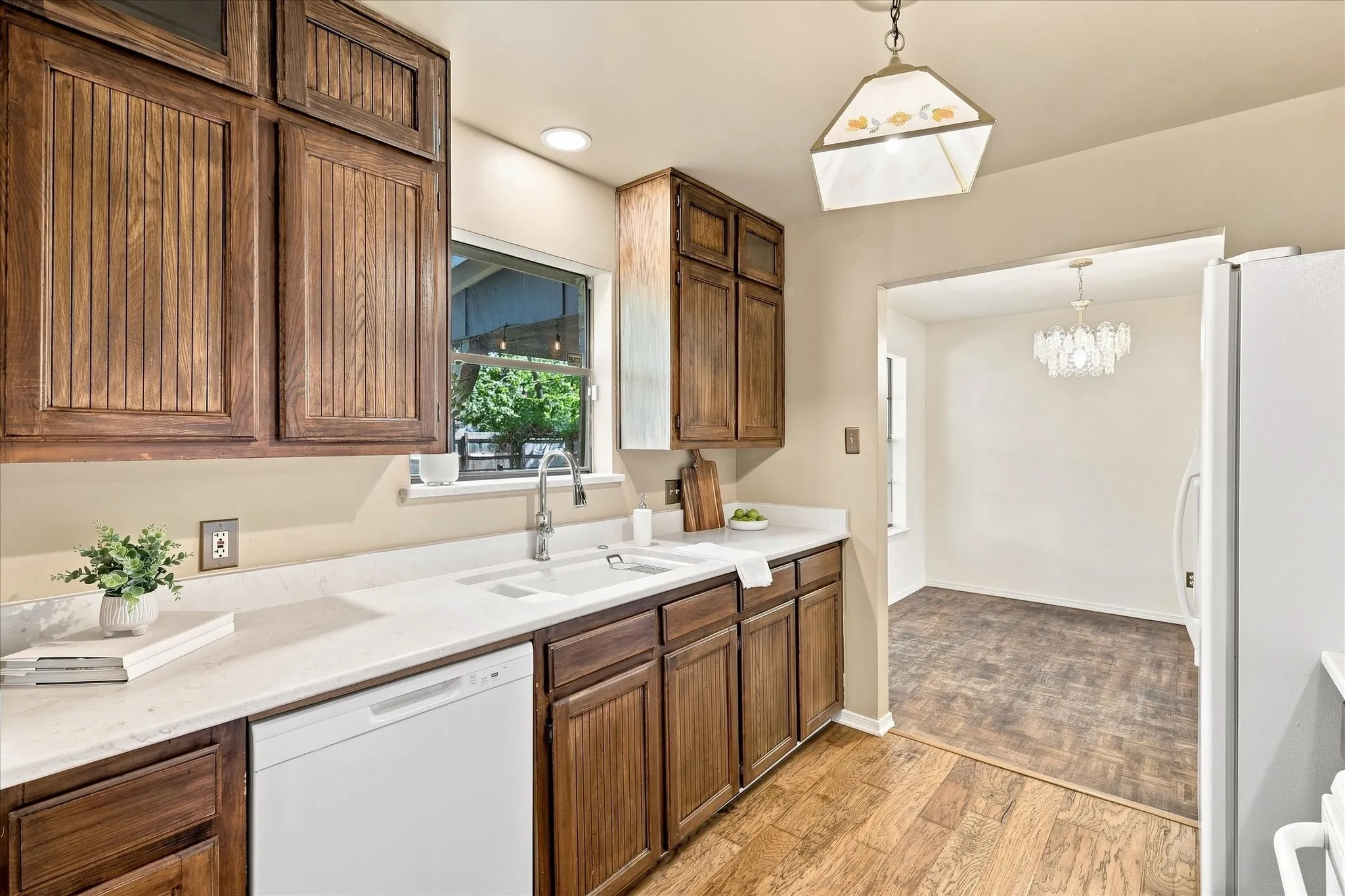 The kitchen features ceiling-height cabinets, marble countertops, a Kohler sink, vintage tile backsplash behind the range and recently replaced dishwasher and garbage disposal.