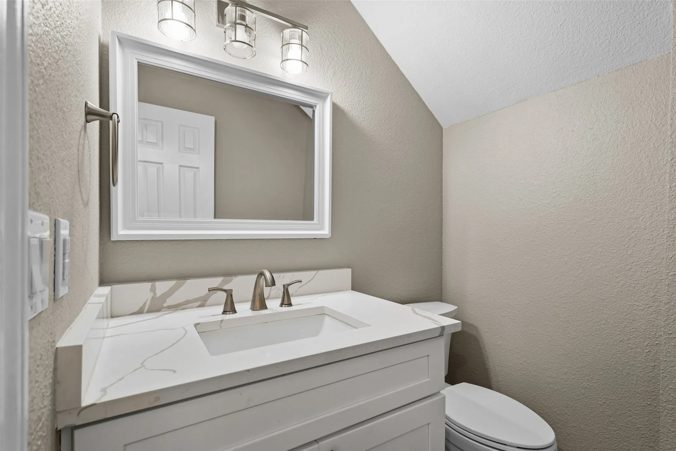 Vanity with an integrated rectangular sink, bronze-finish faucet, and white countertop with​​‌​​​​‌​​‌‌​‌‌​​​‌‌​‌​‌​‌​​​‌​​ veining