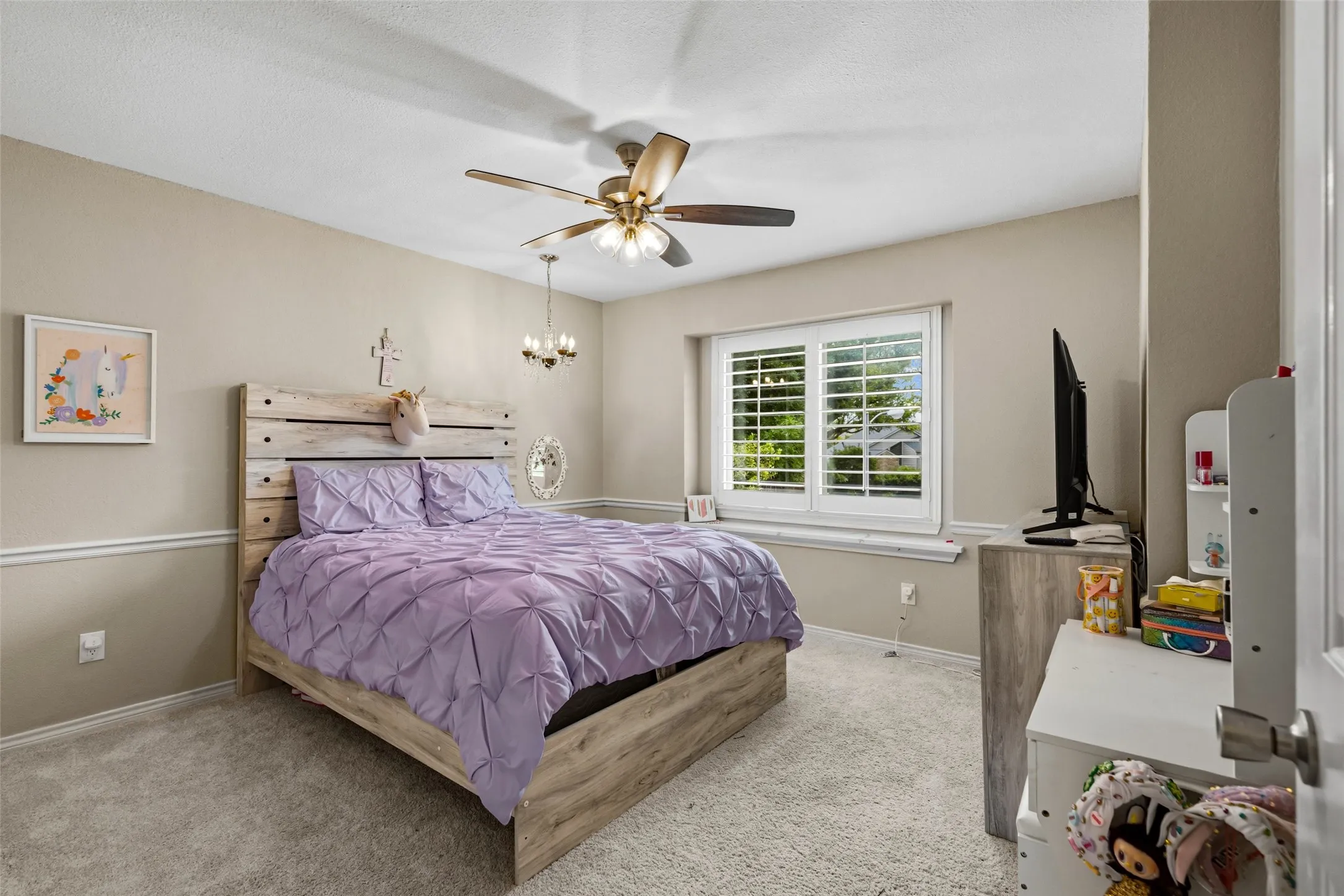Window with plantation shutters, ceiling fan, and carpeted flooring