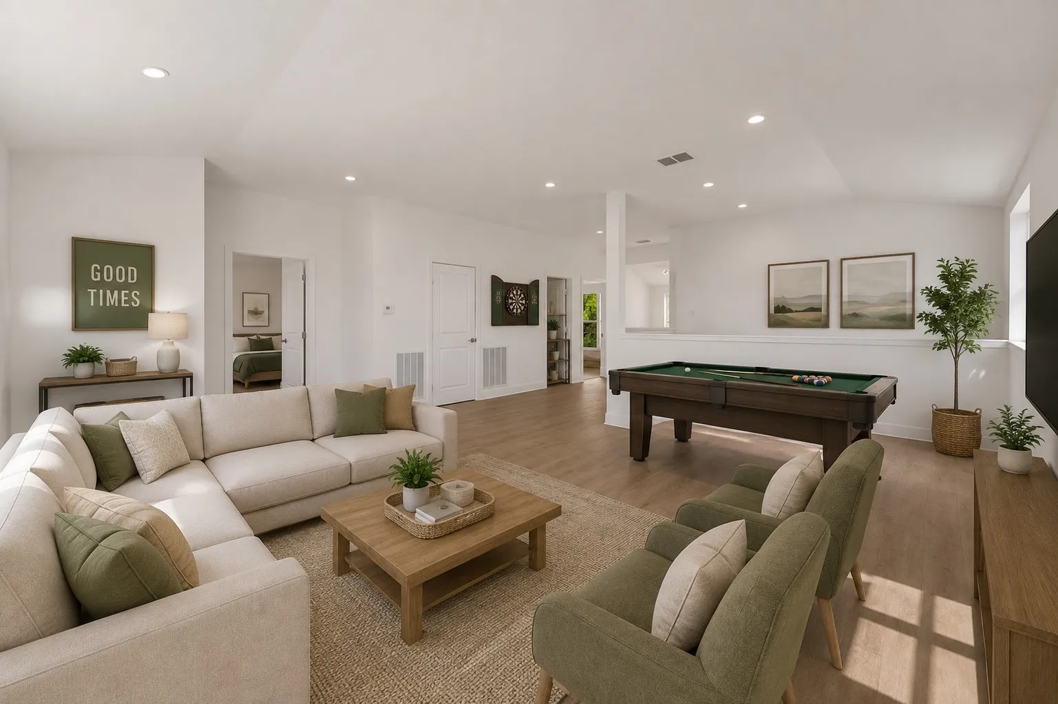 Spacious living area featuring a vaulted ceiling, recessed lighting, and wood-finish flooring