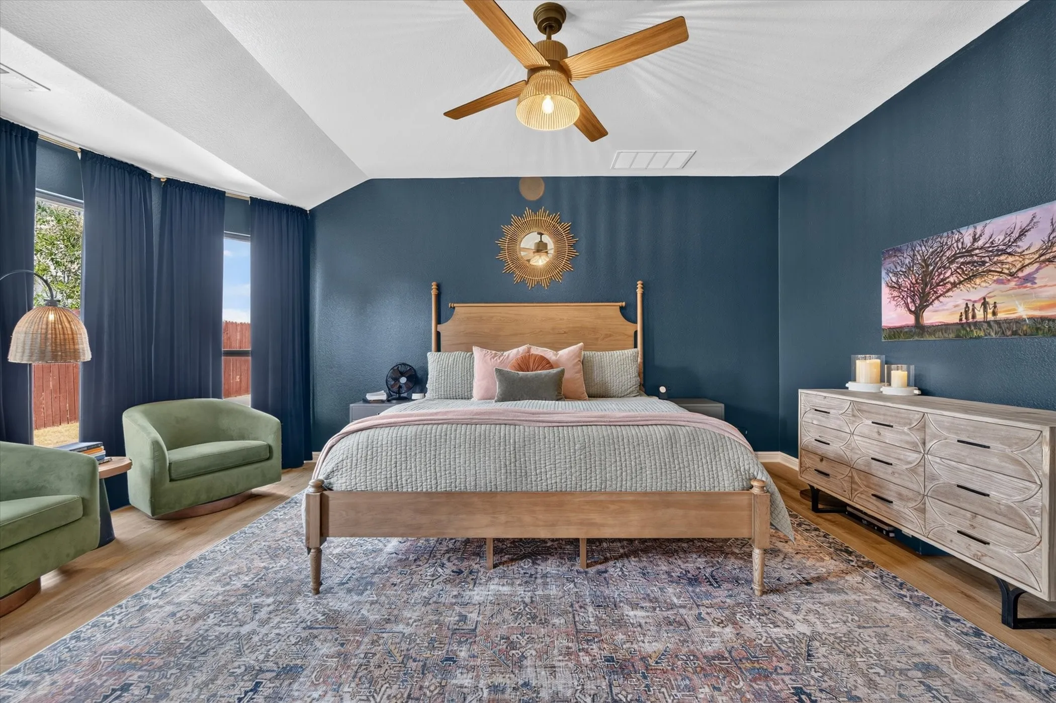 Vaulted ceilings, wood-finish flooring, and a ceiling fan with integrated lighting