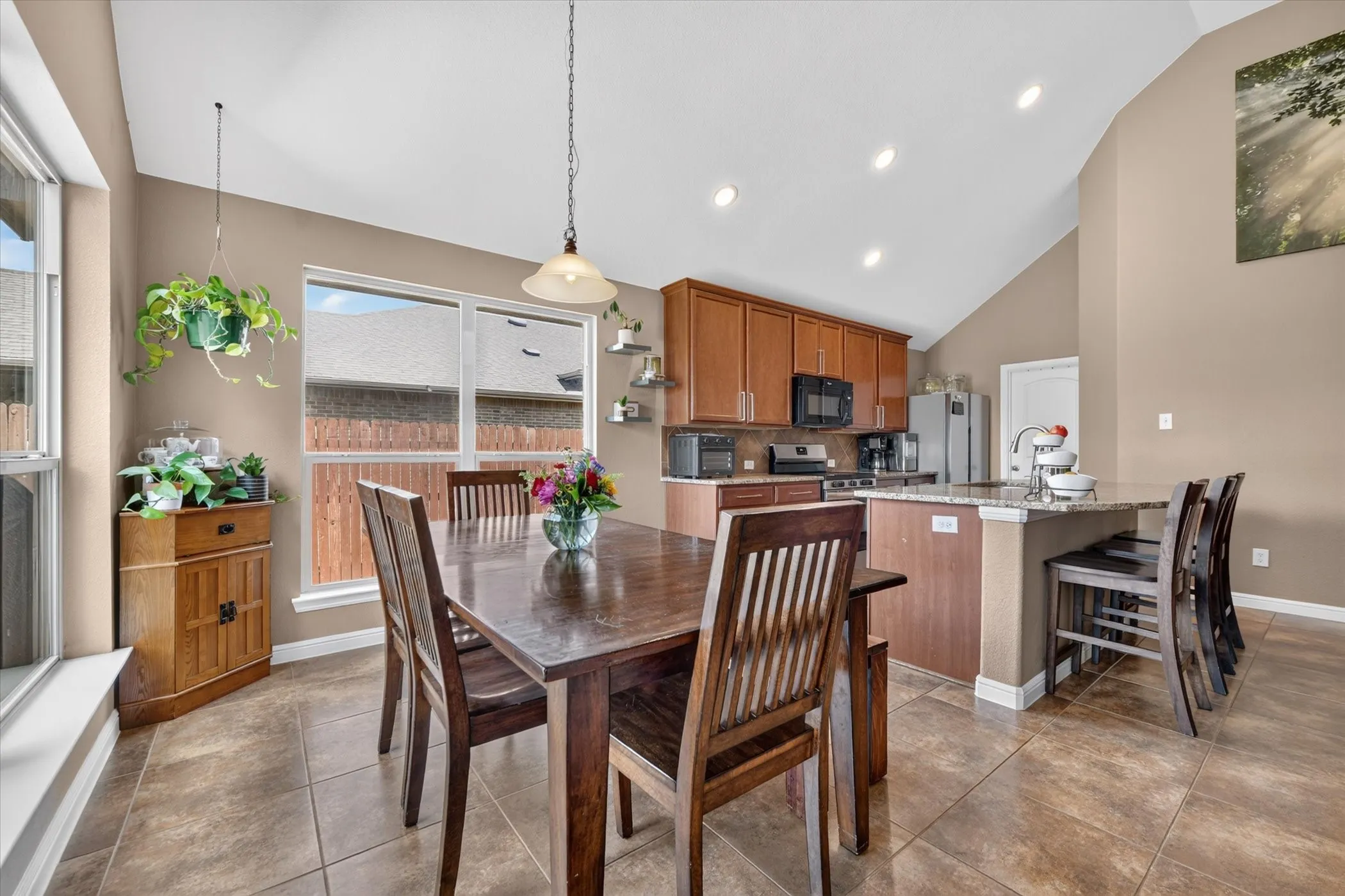 Vaulted ceilings, recessed lighting, and tile flooring