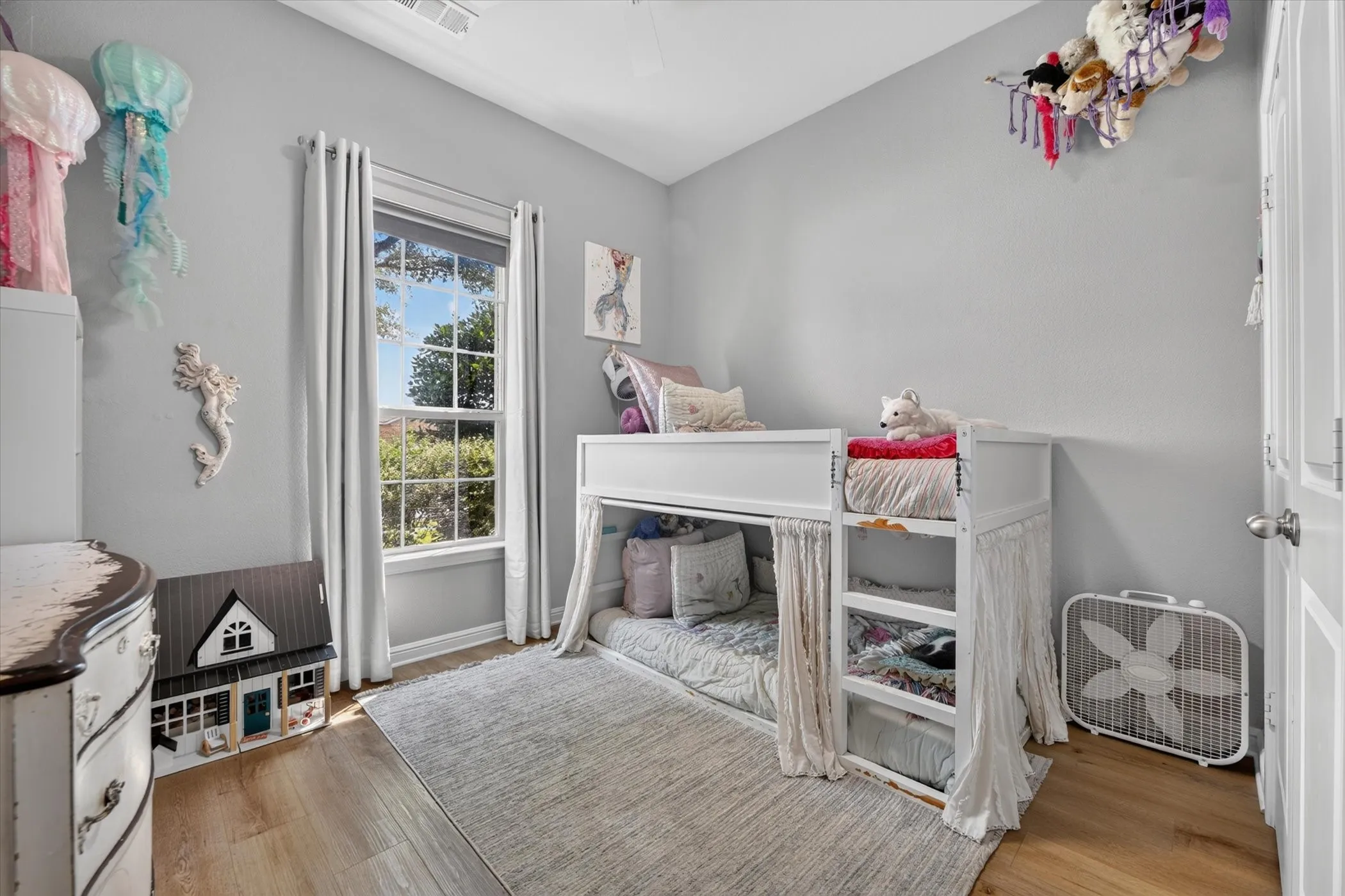 Recessed lighting, wood-finish flooring, and a window with natural light