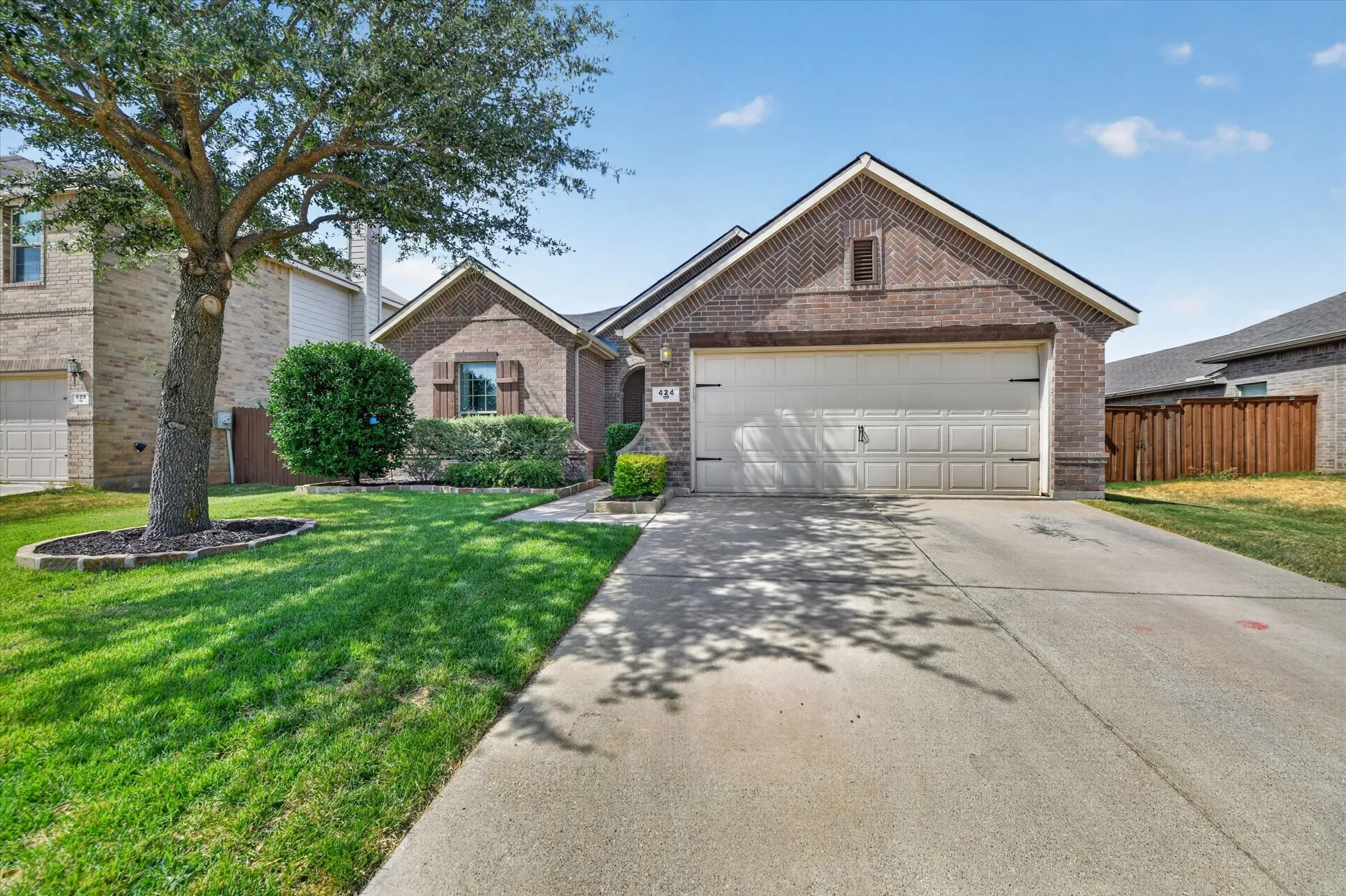 Brick exterior with an attached garage and a concrete driveway