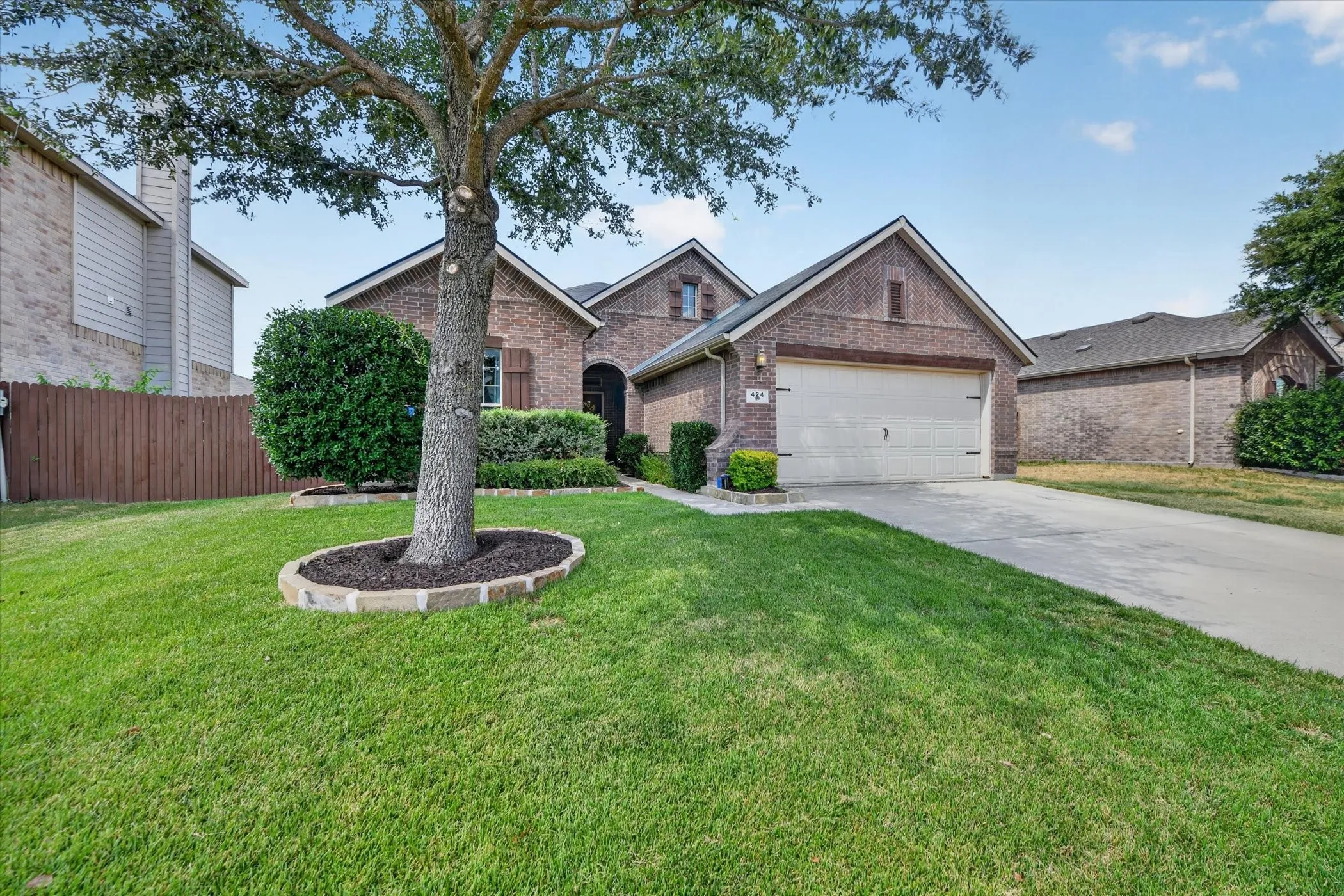 Brick exterior with a gabled roof and attached garage