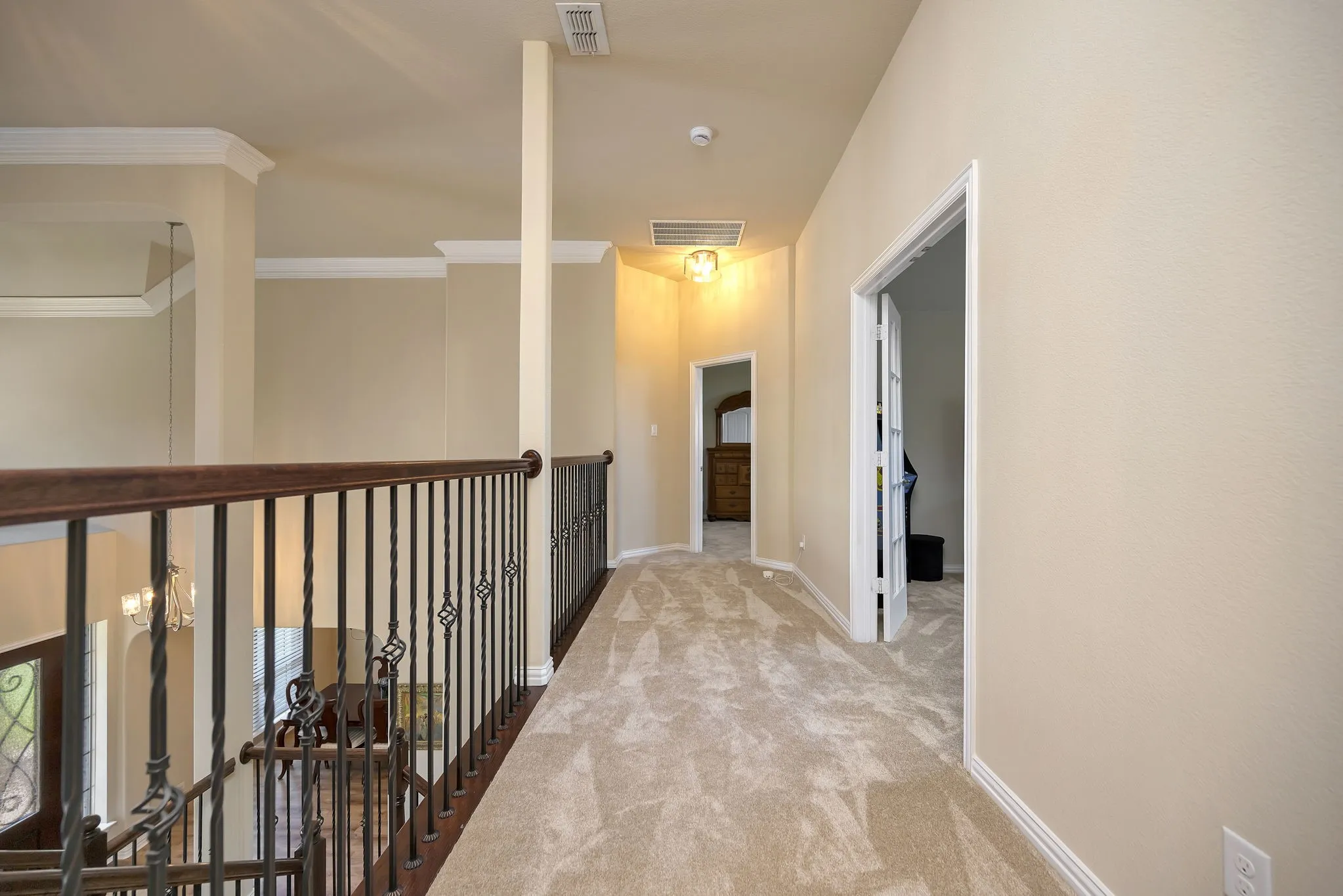 Hallway leading to game room and second primary bedroom.