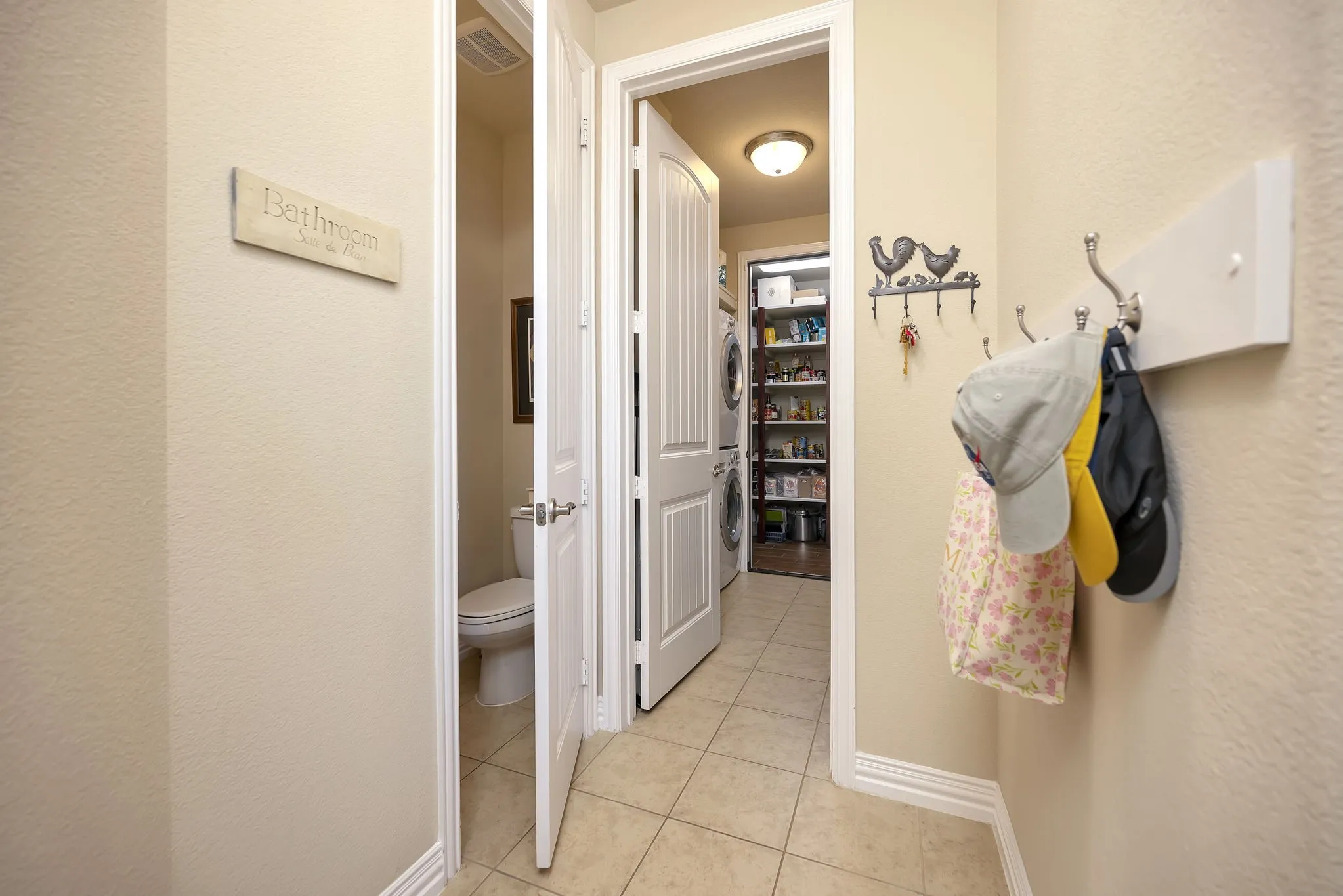 Half bathroom, laundry room, and wlak-in pantry area.