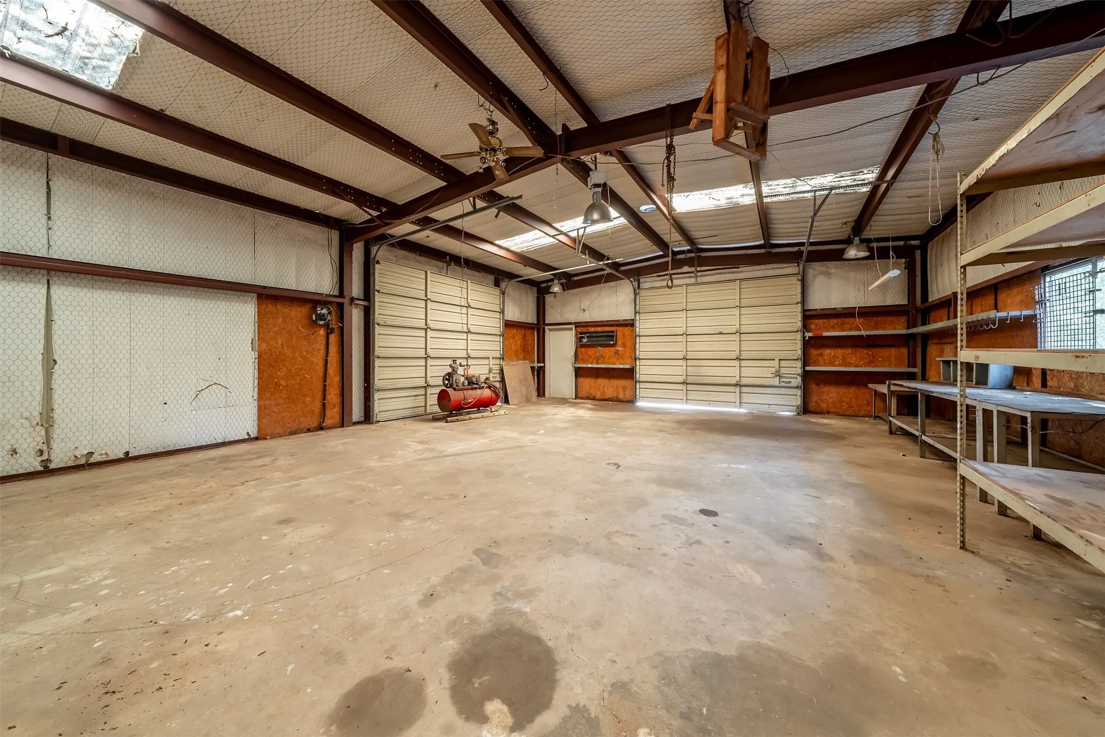 Expansive concrete flooring with exposed metal beam ceiling
