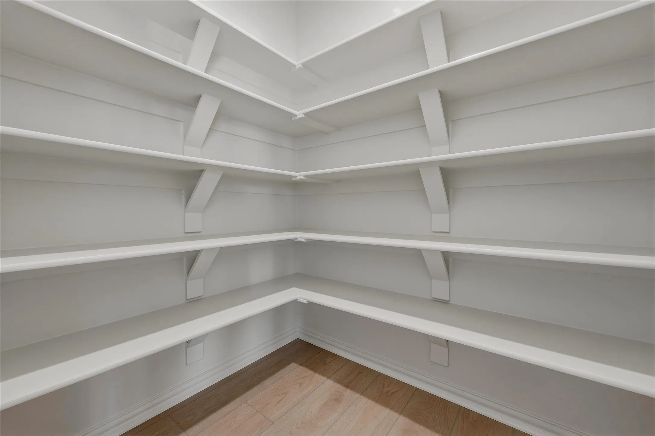 Built-in corner shelving with white finishes