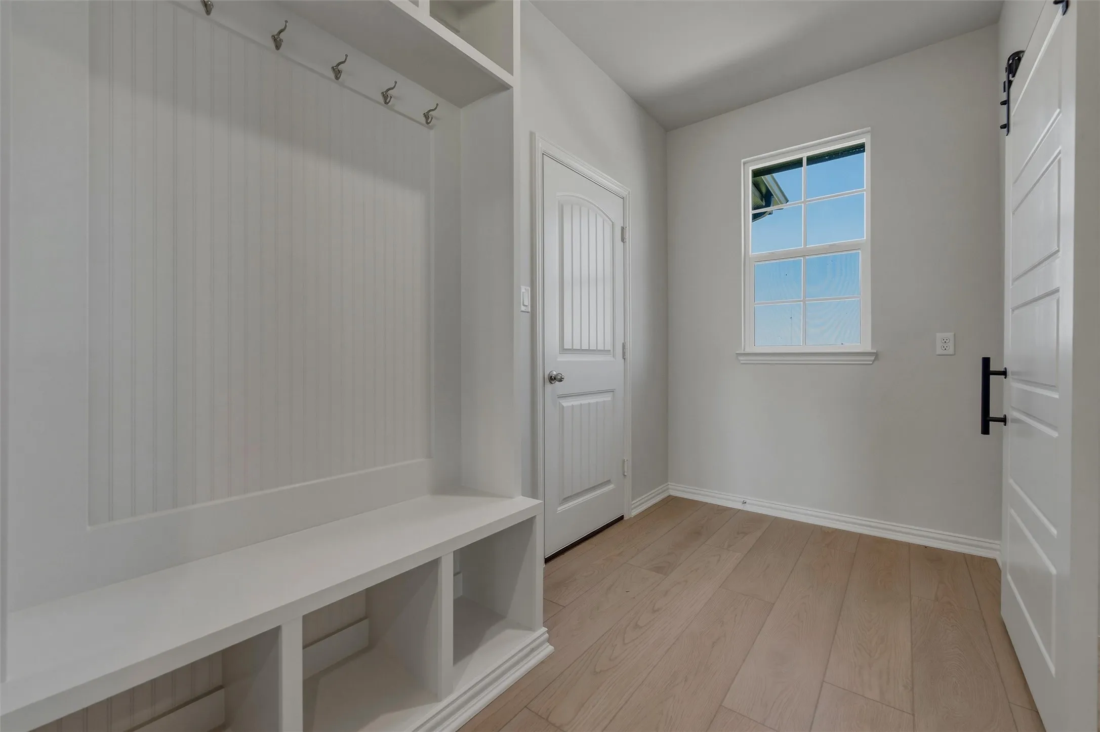 Built-in mudroom bench with storage cubbies and coat hooks
