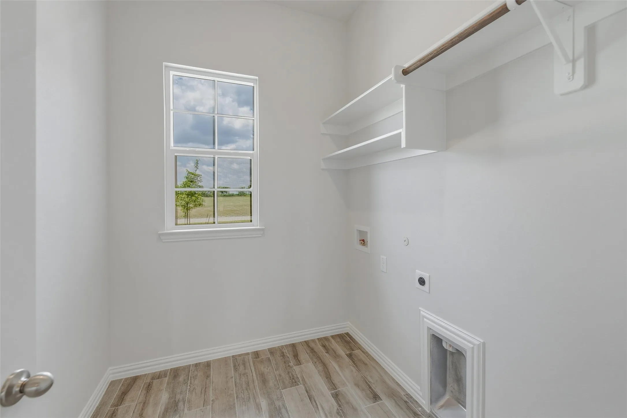 Wood-finish tile flooring complemented by white walls