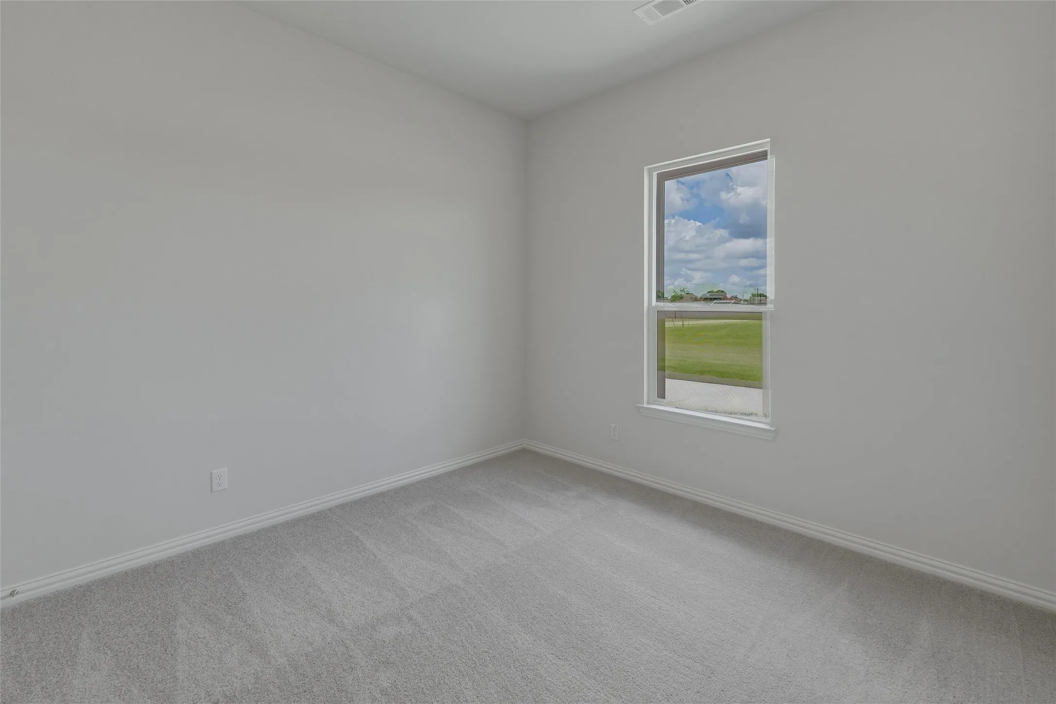 Neutral wall tones, light-toned carpeting, and a rectangular window