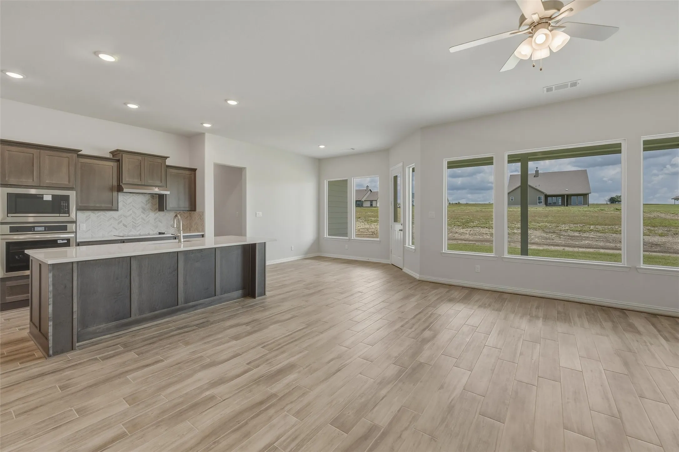 Spacious open-concept layout with wood-finish flooring