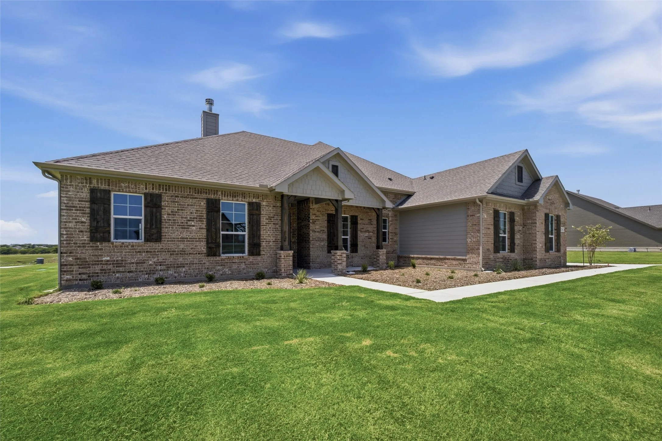Brick exterior with gabled roof lines and dark window shutters