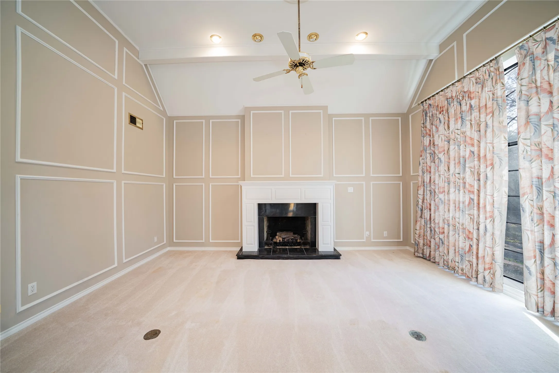 Spacious room featuring a vaulted ceiling with exposed beams, a ceiling fan, and recessed lighting