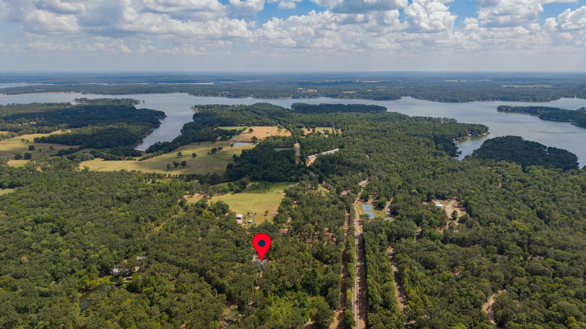 Expansive wooded acreage with a prominent water feature