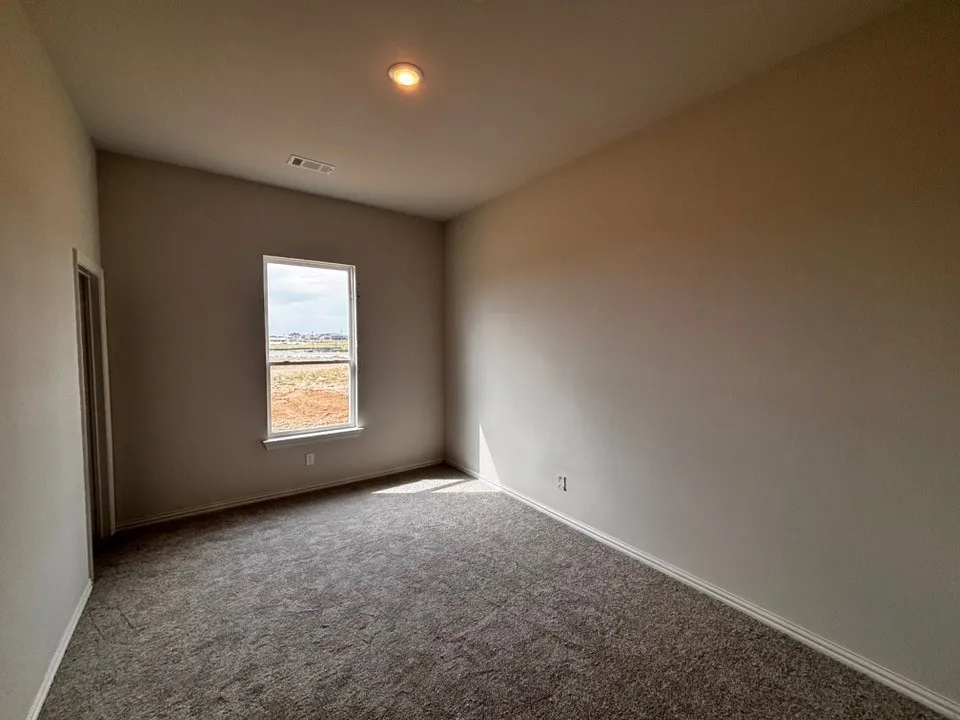 Neutral wall paint, recessed lighting, and grey carpet