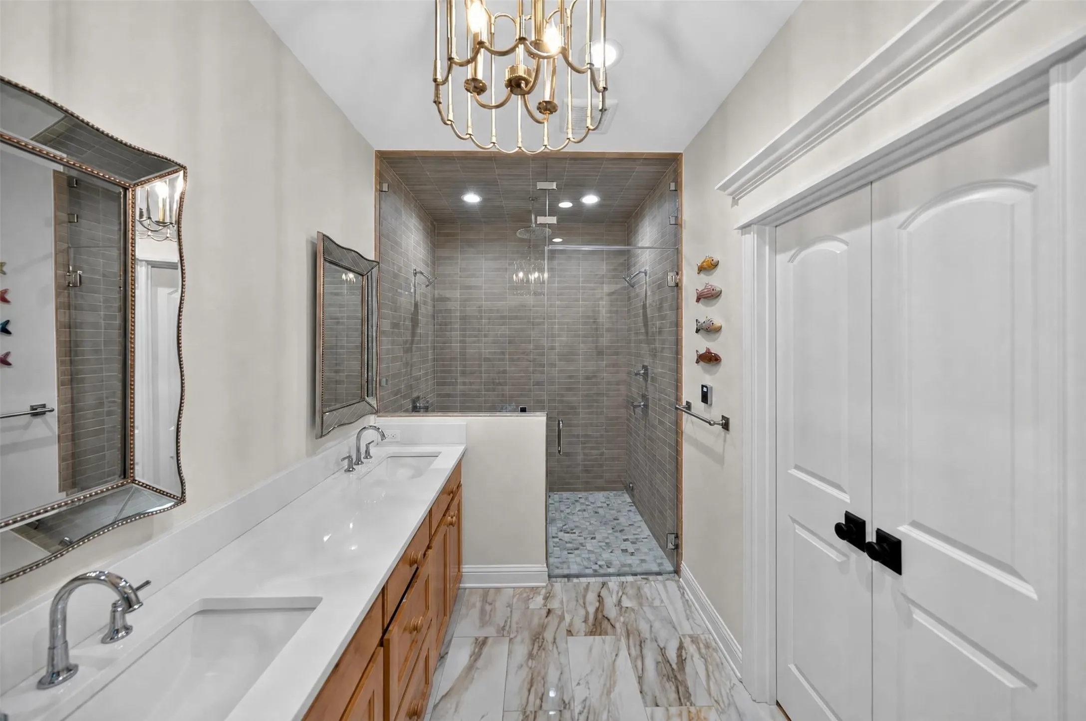 Dual vanity with undermount sinks, wood-finish cabinetry, and a white countertop