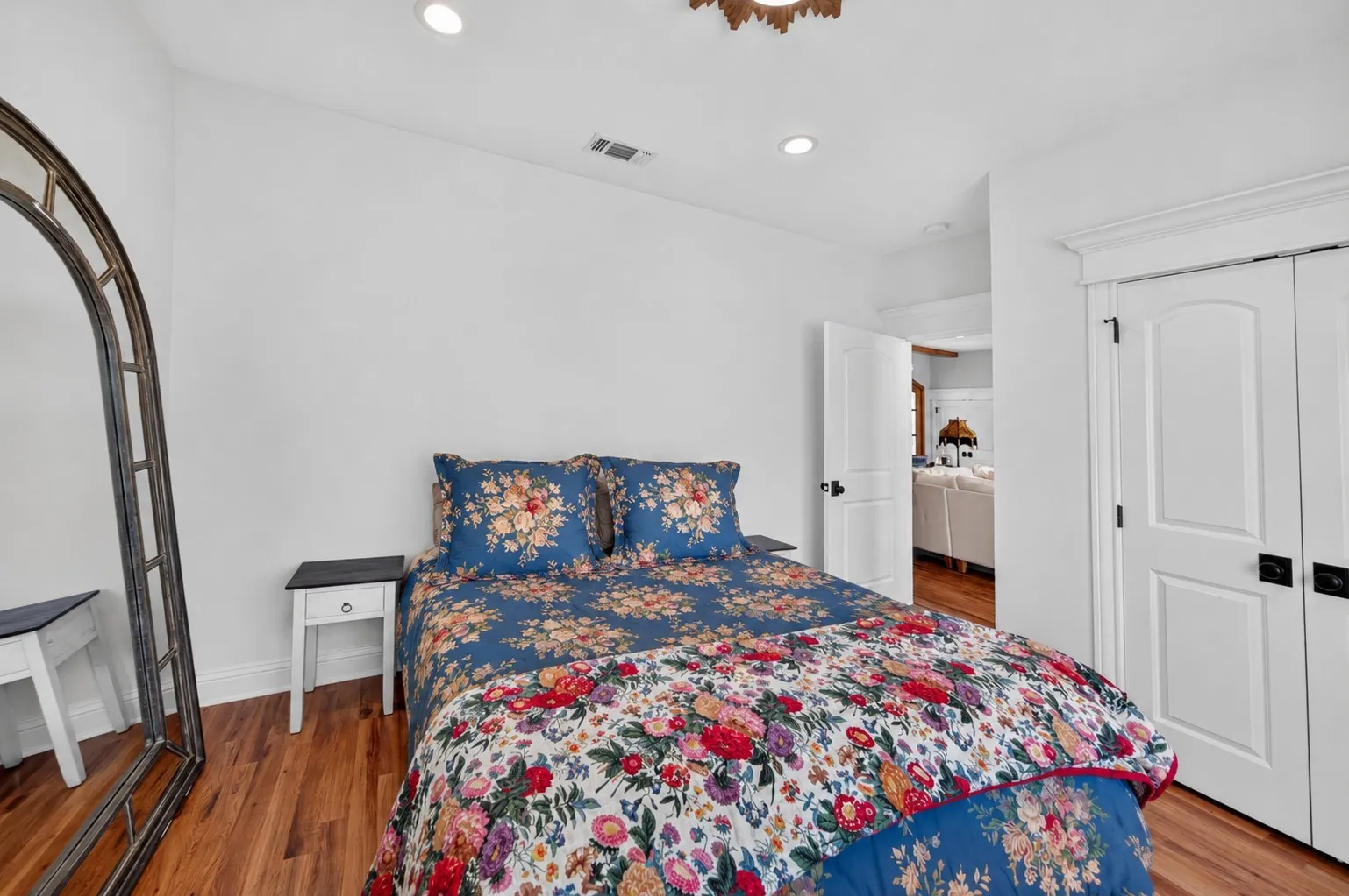 Guest bedroom off of living room.
recessed lighting, and white paneled doors with dark hardware