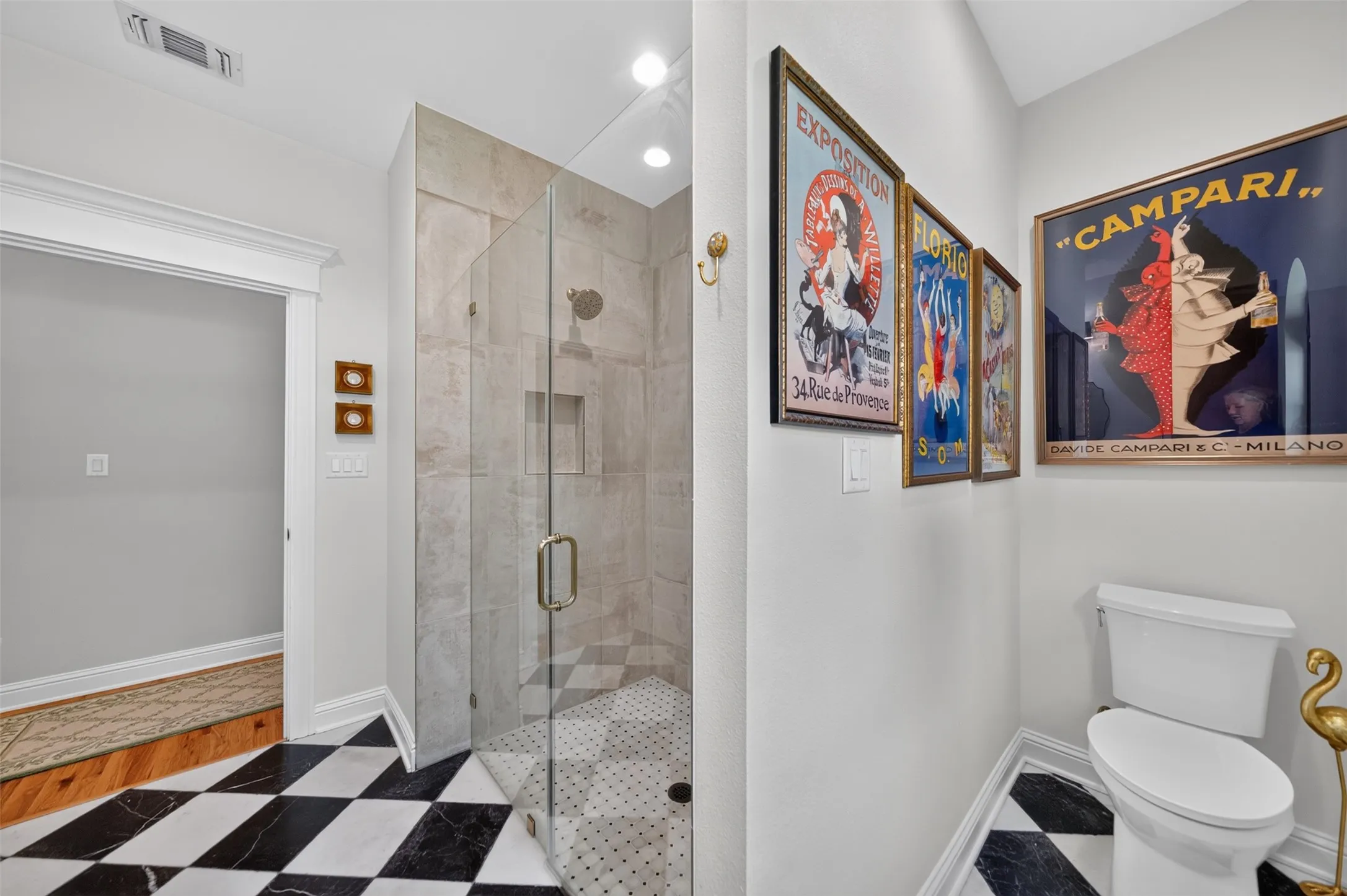 Glass-enclosed shower with tile surround and integrated niche