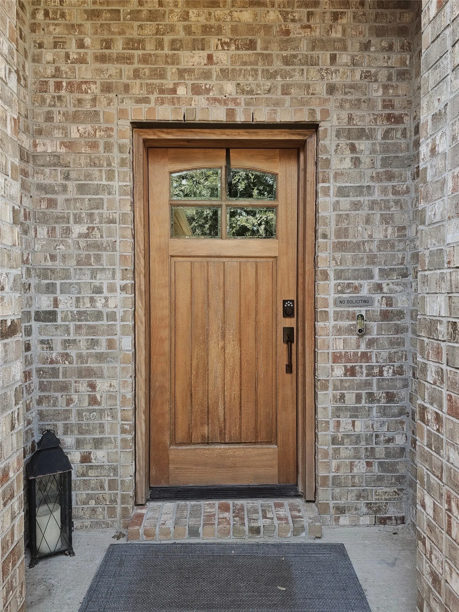 Covered front patio with a camera doorbell.