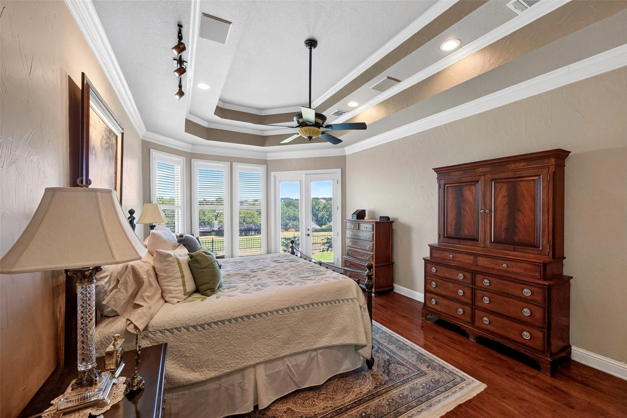 Spacious primary bedroom with box ceiling