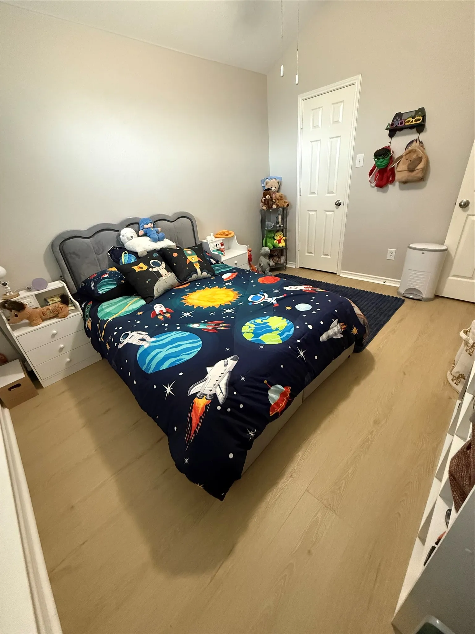 Wood-finish flooring with a neutral wall color and white trim