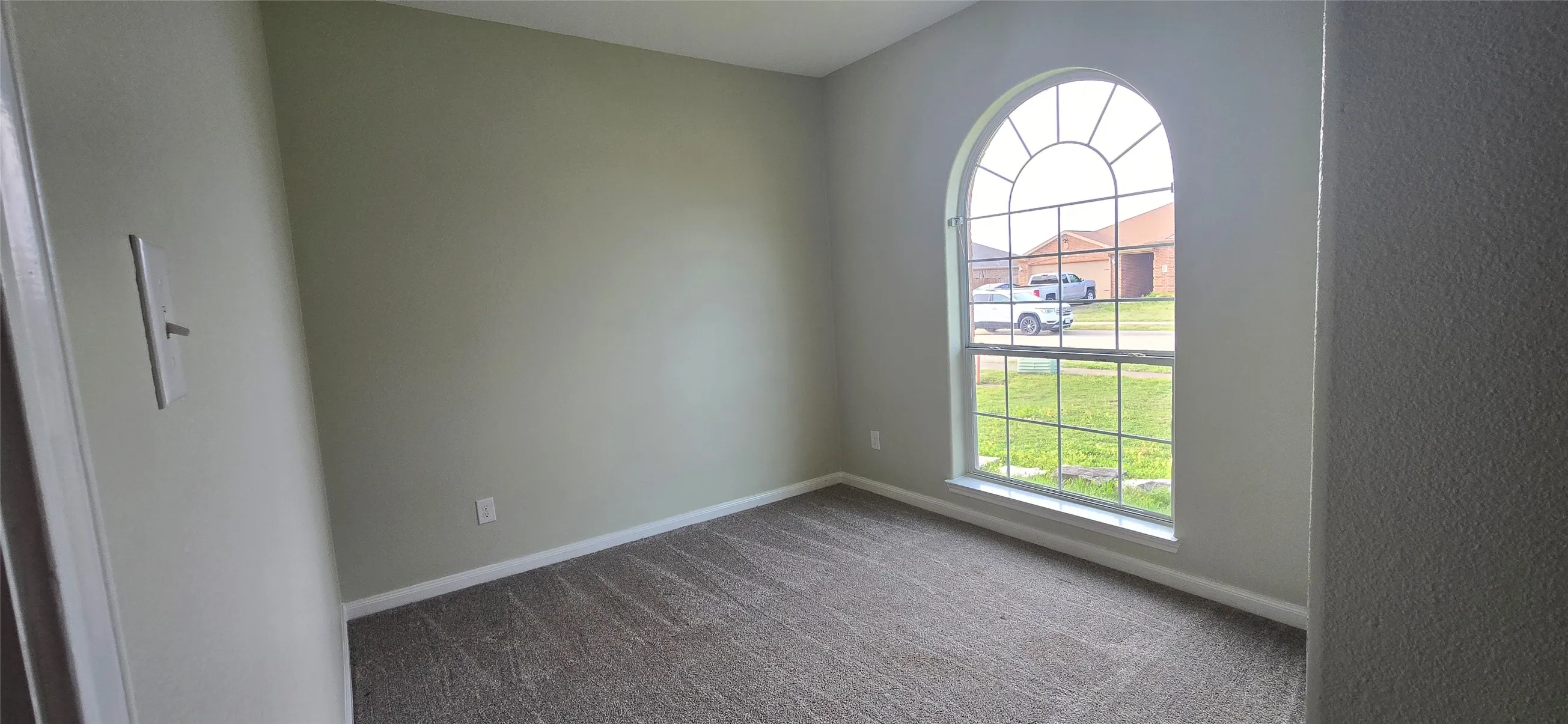 Carpeted spare room with baseboards