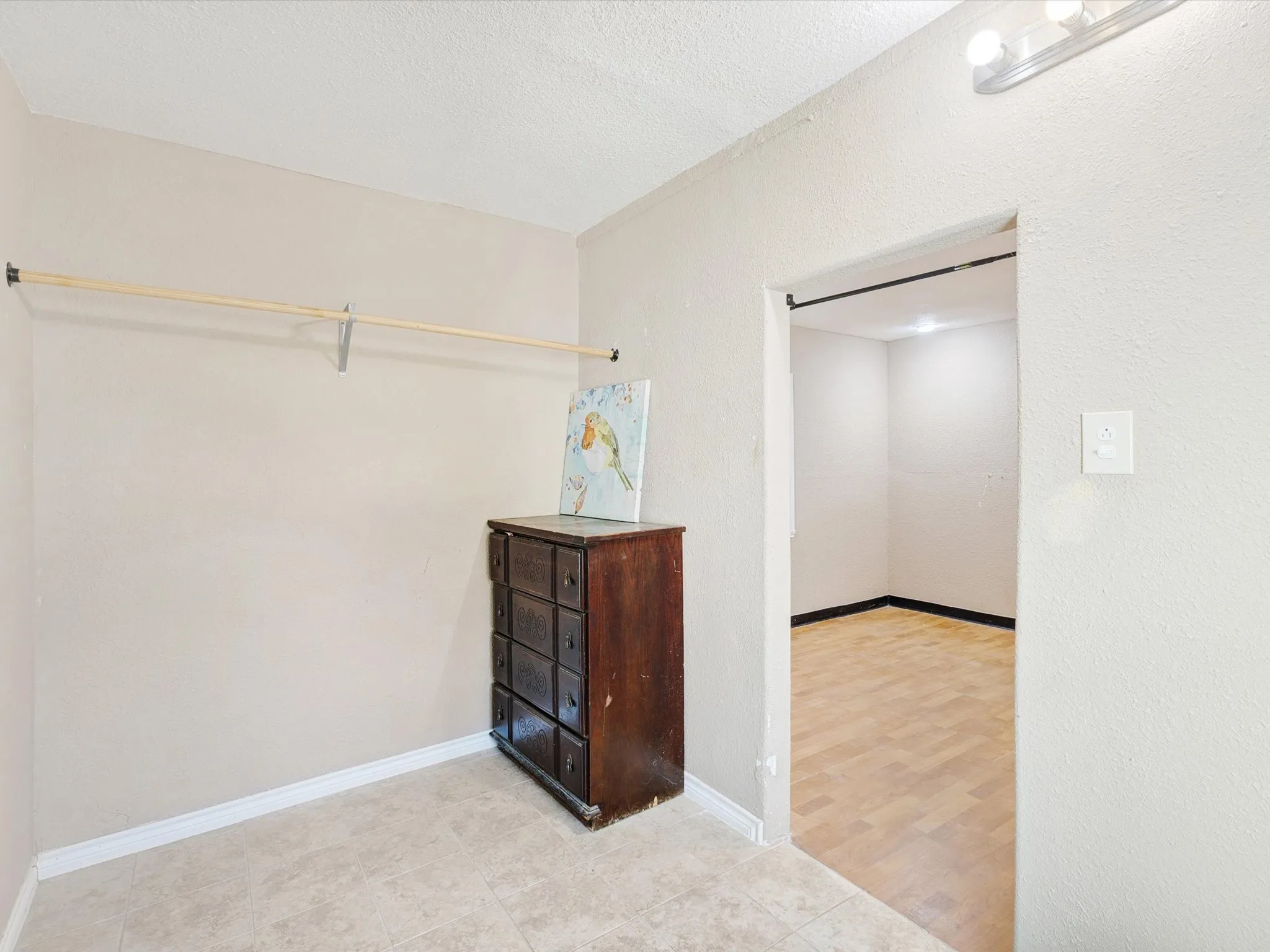 Recessed lighting, tile flooring, and wall-mounted light fixture