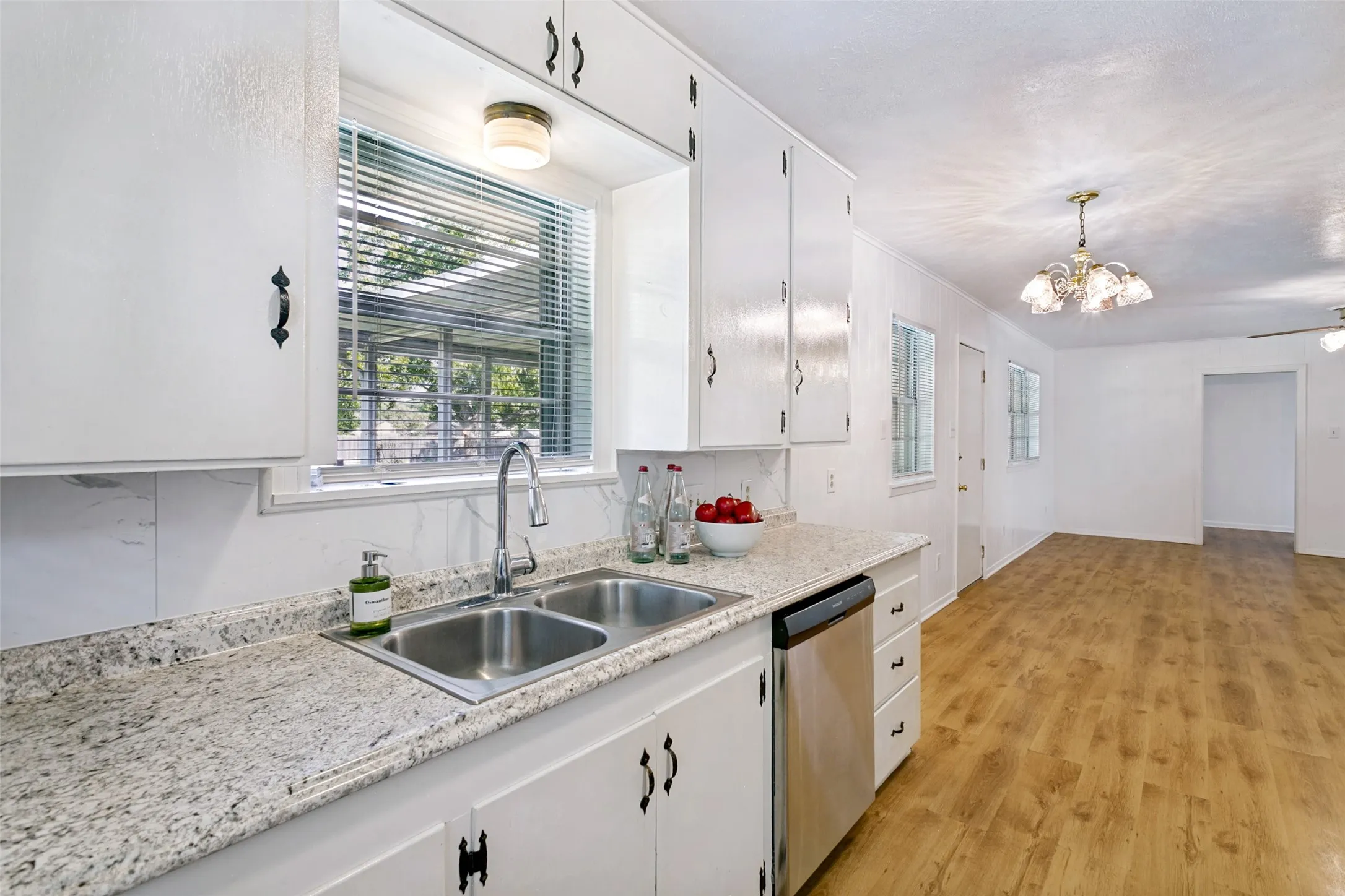 Sink overlooks spacious backyard