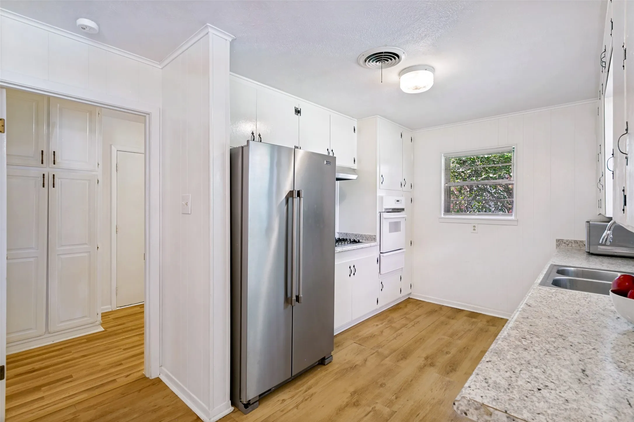 Kitchen with stainless refrigerator