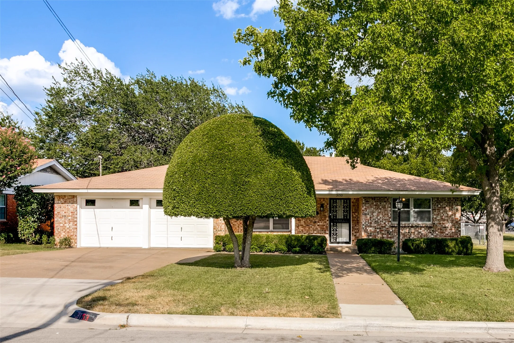 Front of house with mature landscaping