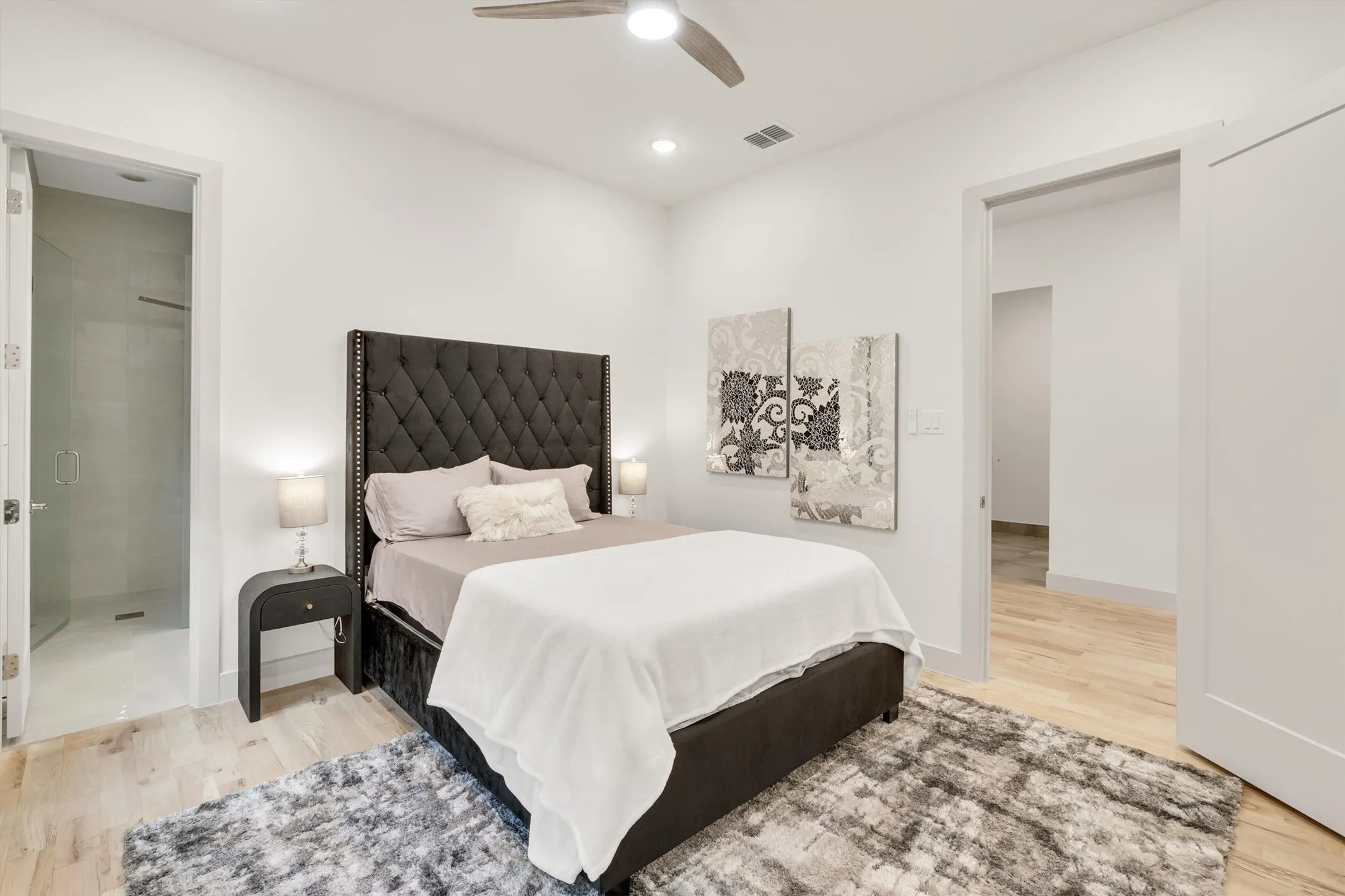 Recessed lighting, ceiling fan, light wood-finish flooring, and a shower with glass enclosure