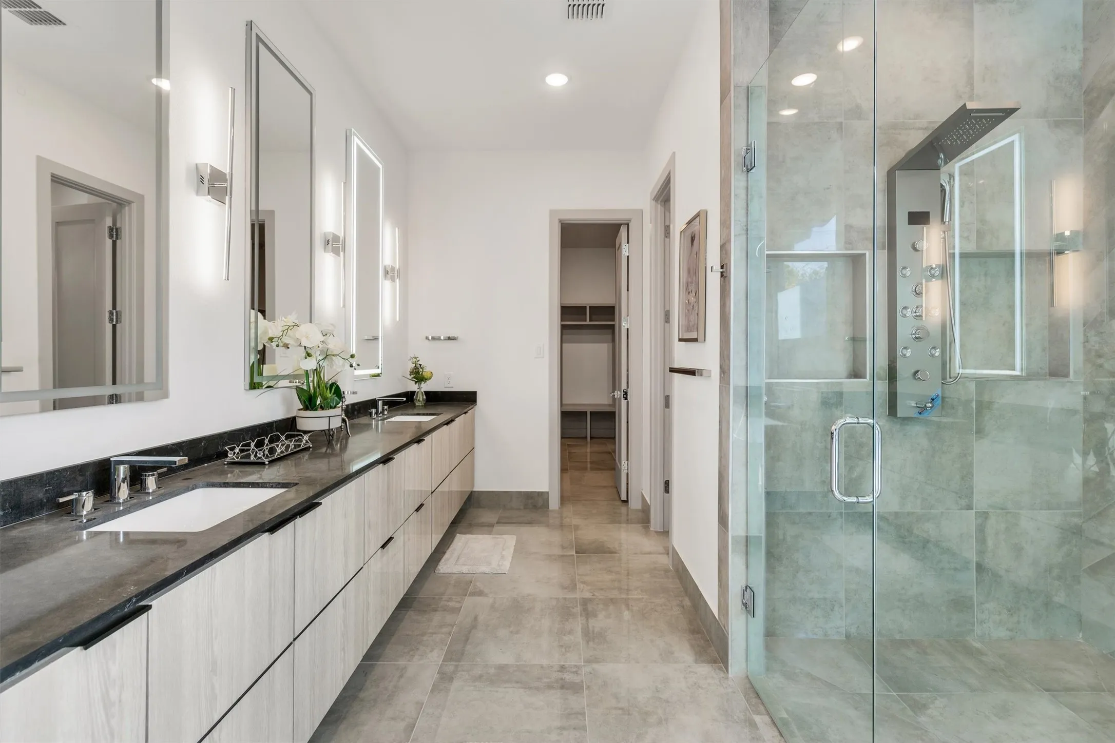 Dual vanity with undermount sinks and dark countertops