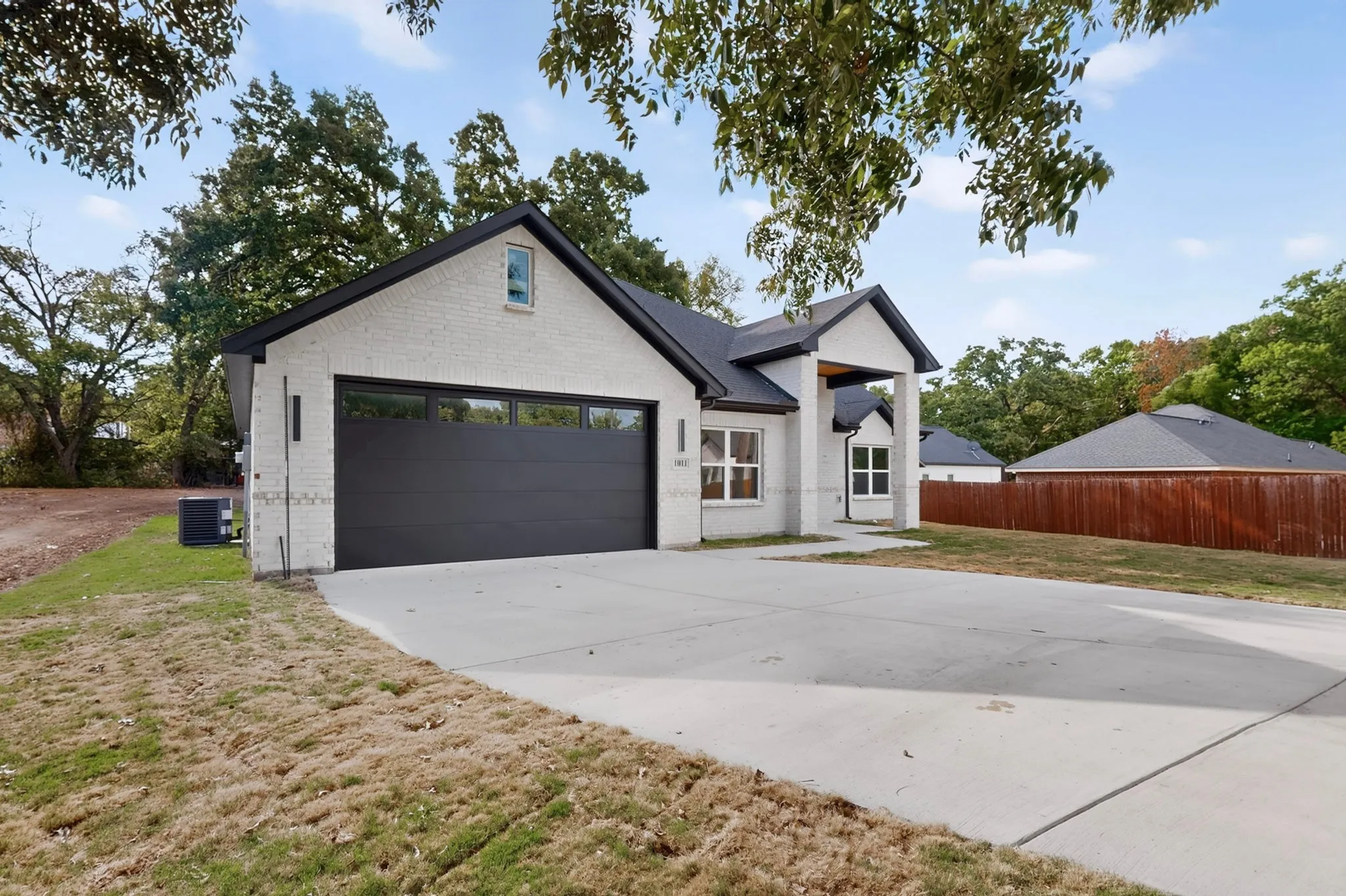 Contemporary architecture with a white brick exterior and a contrasting black roof