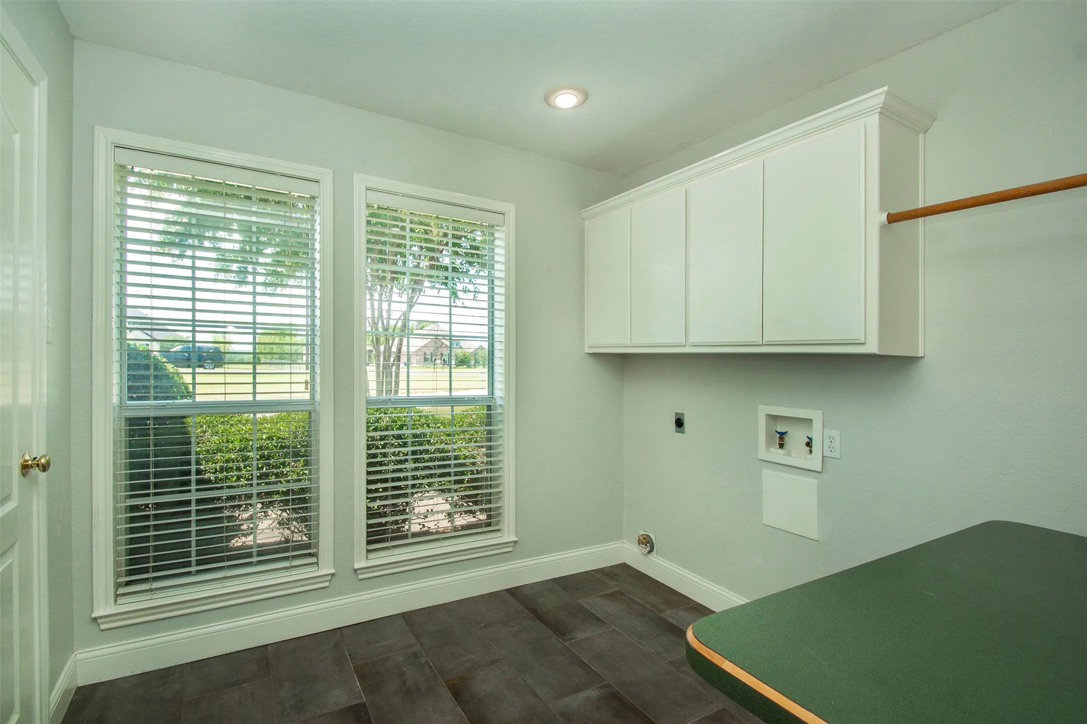 Separate utility room with built in folding counter and pantry
