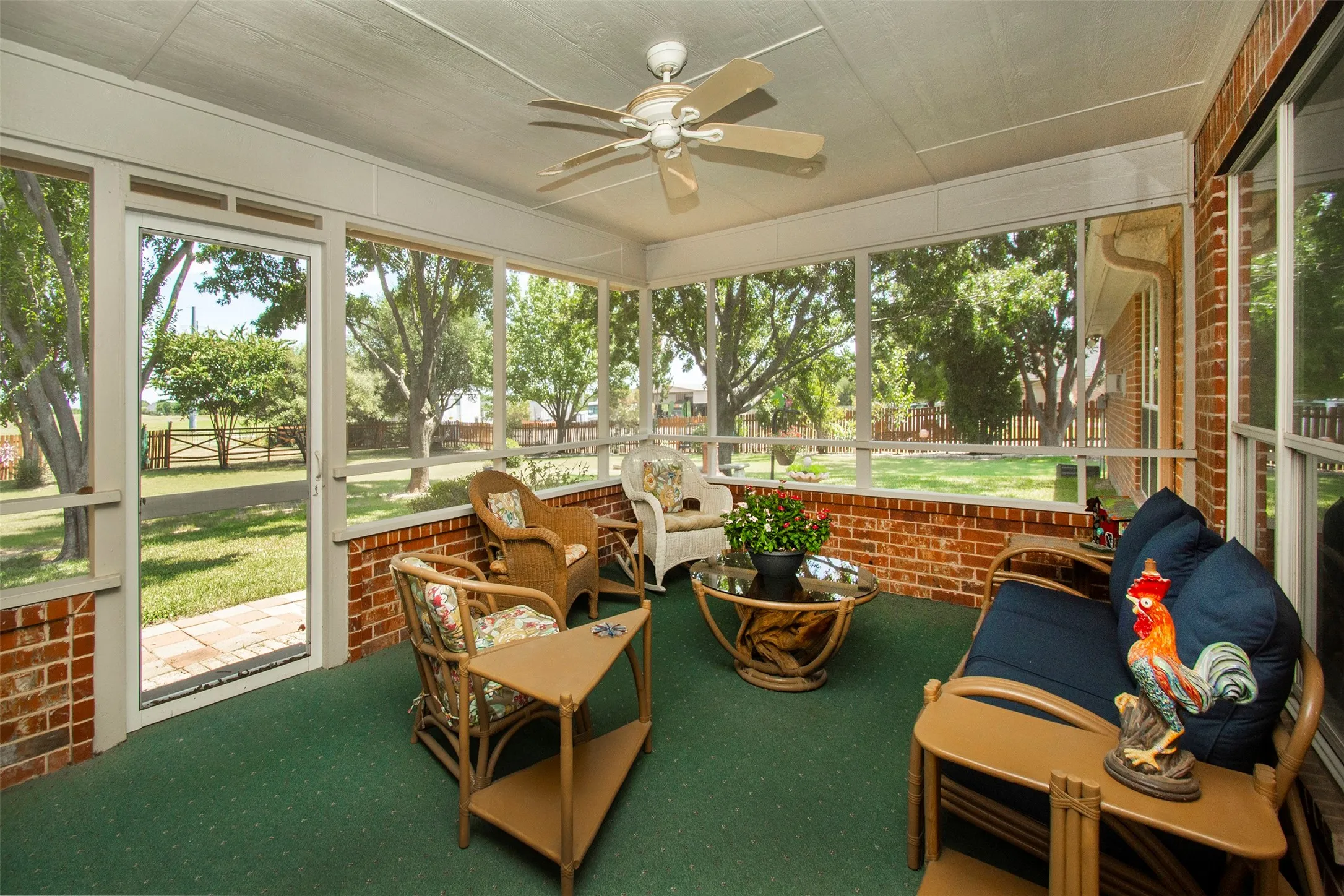 Spacious screened-in back porch overlooking the beautiful, private backyard