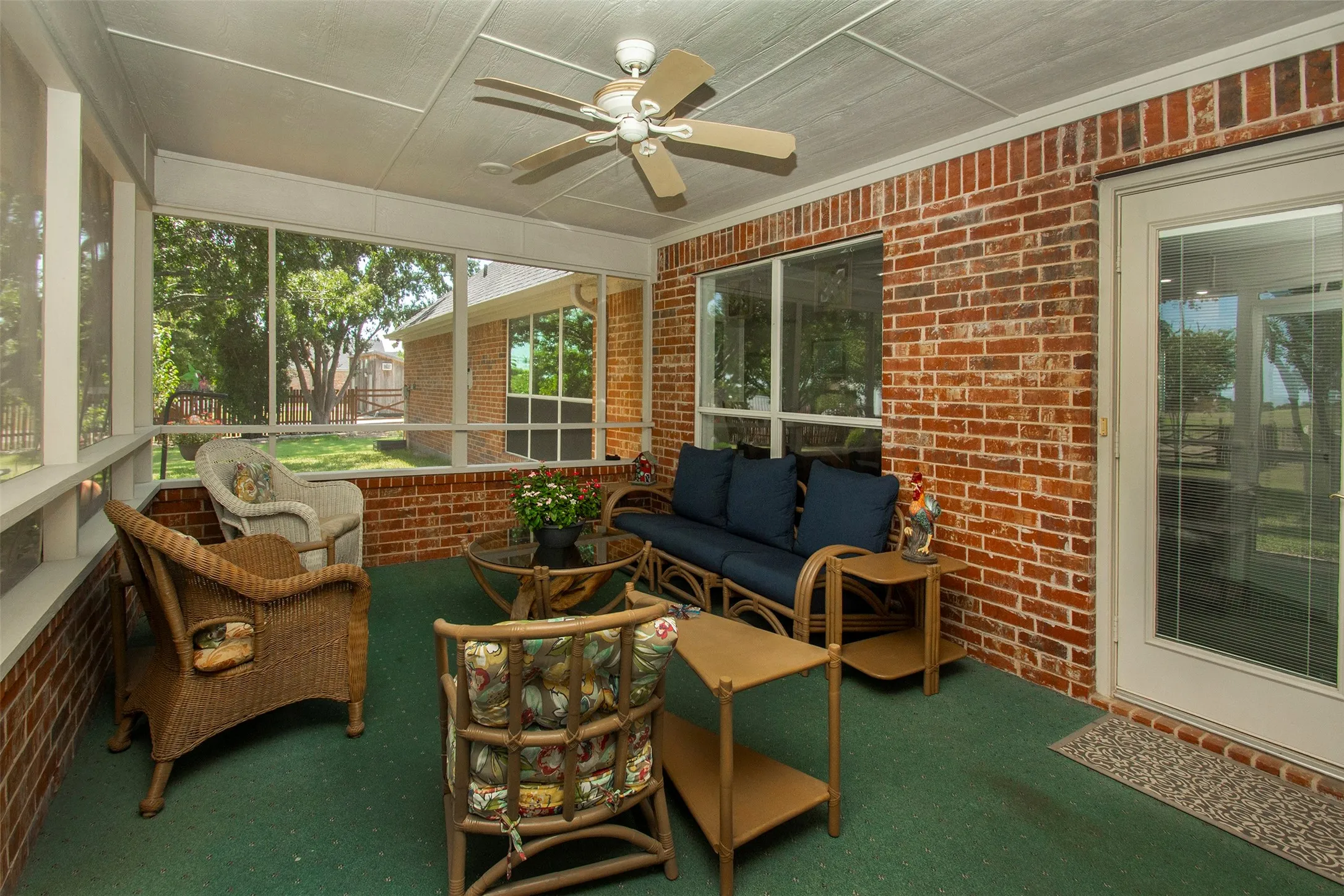 Spacious screened-in back porch overlooking a beautiful private backyard