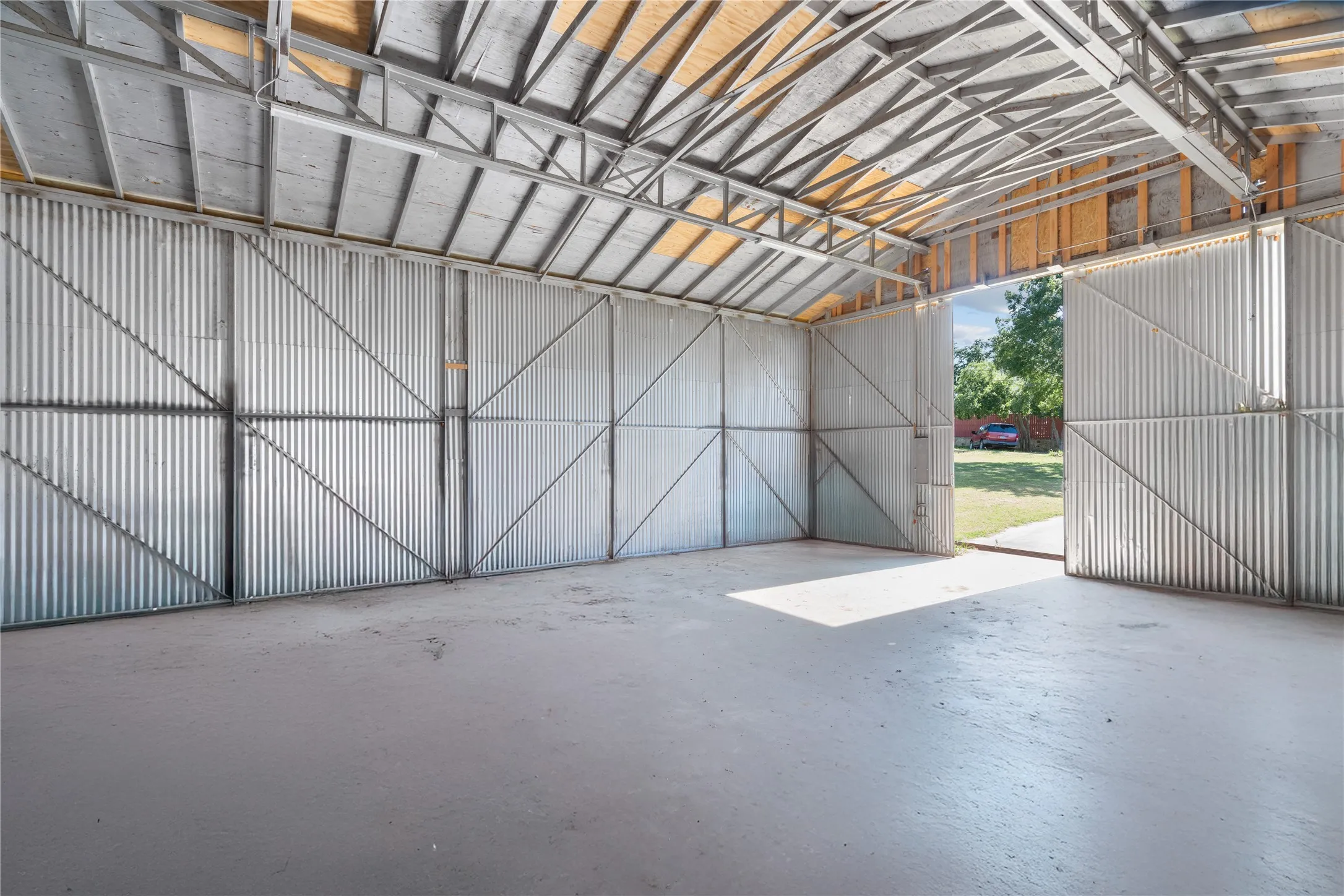Garage featuring metal wall